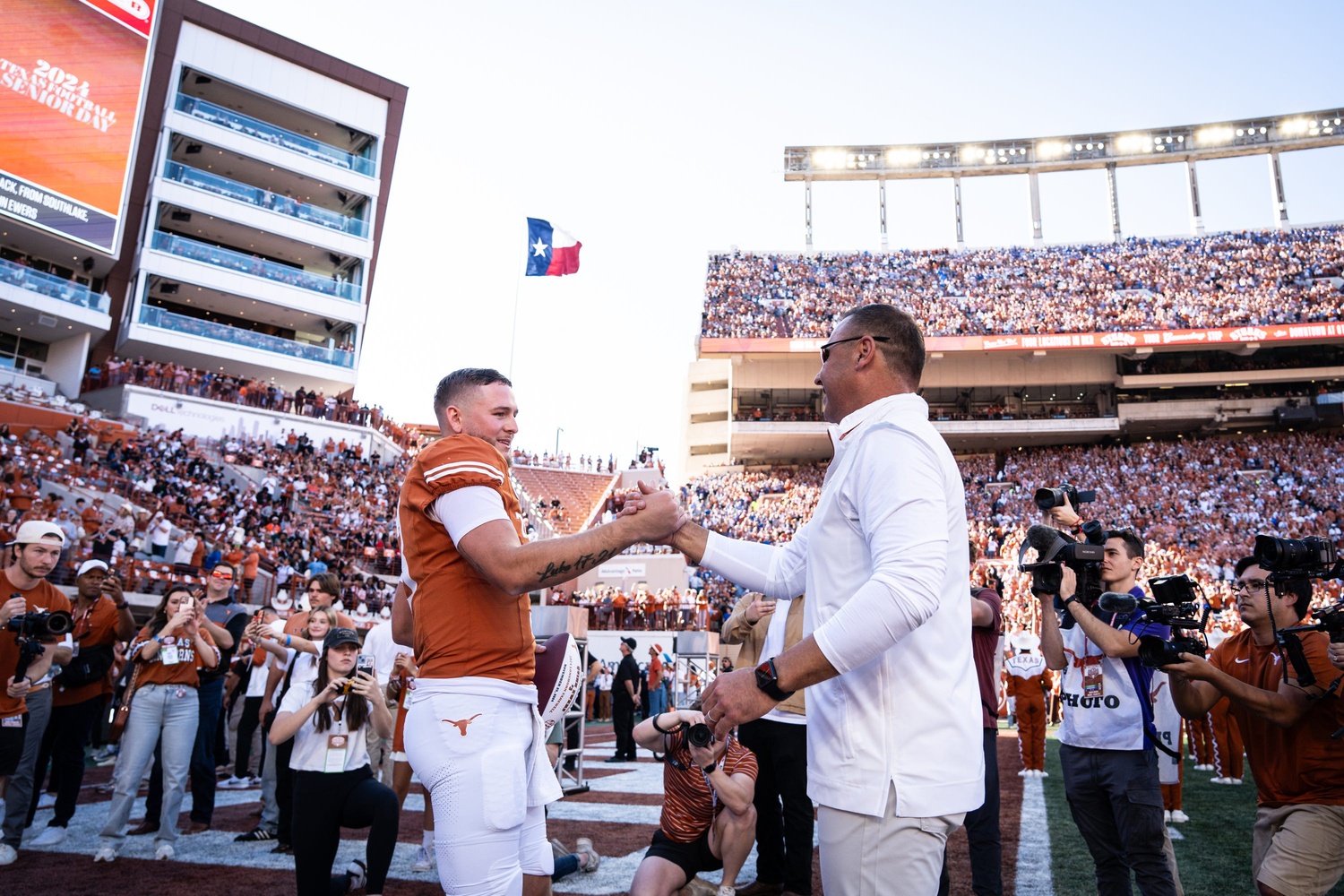 Texas Longhorns head coach Steve Sarkisian embraces quarterback Quinn Ewers (3) as Ewers is honored as one of Texas' seniors in their last home game pf the season against the Kentucky Wildcats at Darrell K Royal Texas Memorial Stadium in Austin, Nov. 23, 2024.