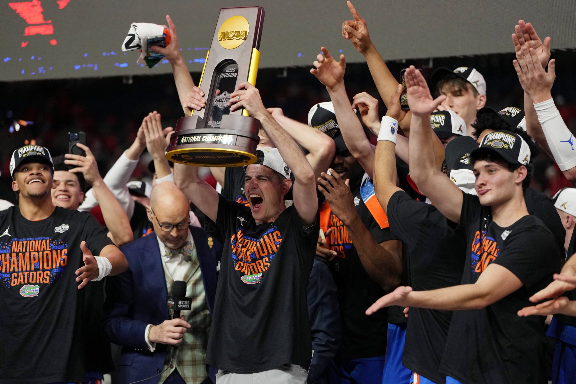 Florida Gators head coach Todd Golden holds up the trophy after winning the national championship game of the Final Four of the 2025 NCAA Tournament at the Alamodome.