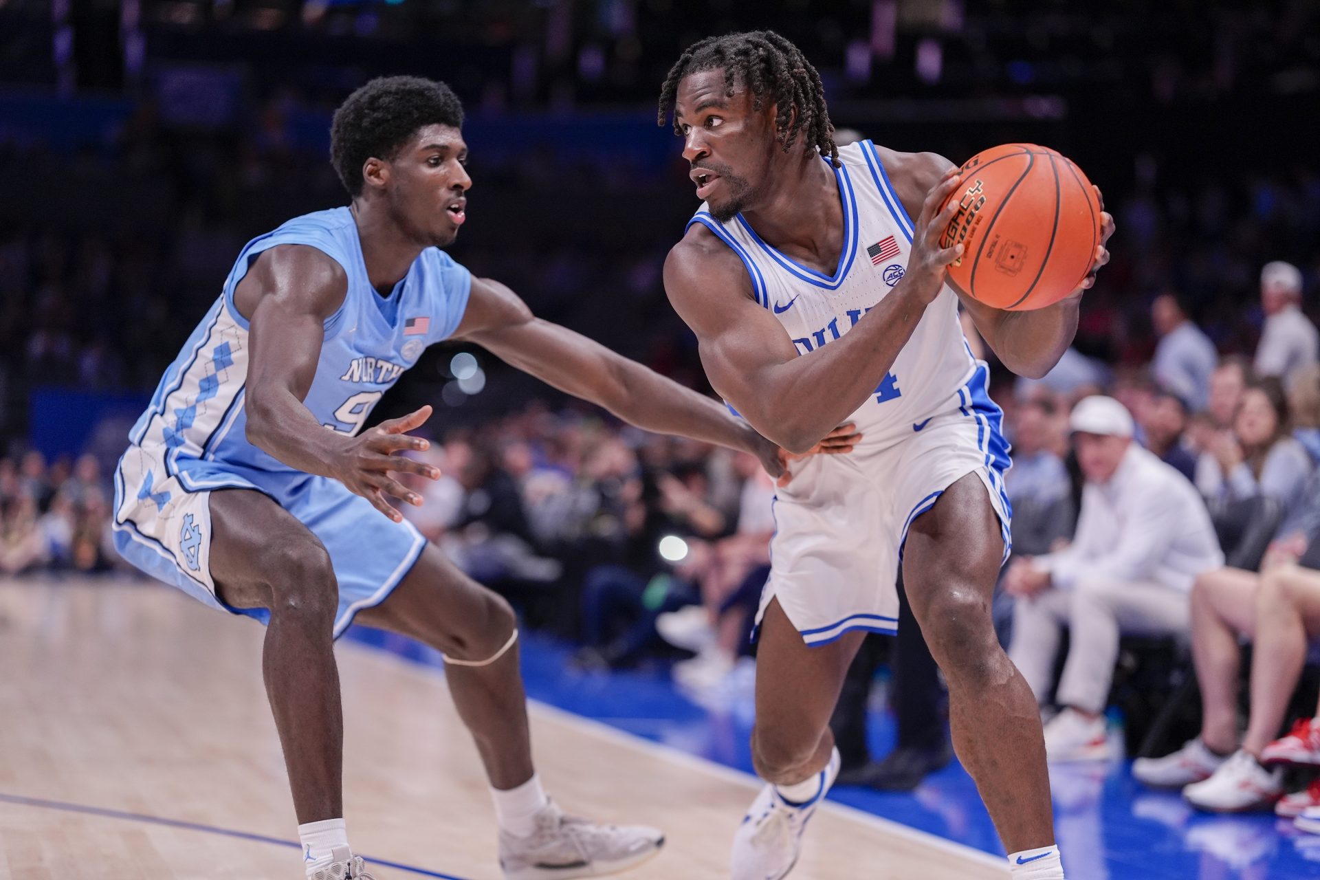 Duke Blue Devils guard Sion James (14) handles the ball against North Carolina Tar Heels guard Drake Powell (9) during the second half at Spectrum Center.