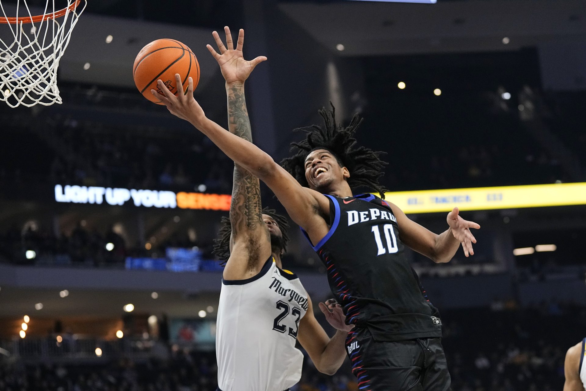 DePaul Blue Demons guard Jaden Henley (10) shoots over Marquette Golden Eagles forward David Joplin (23) during the first half at Fiserv Forum.