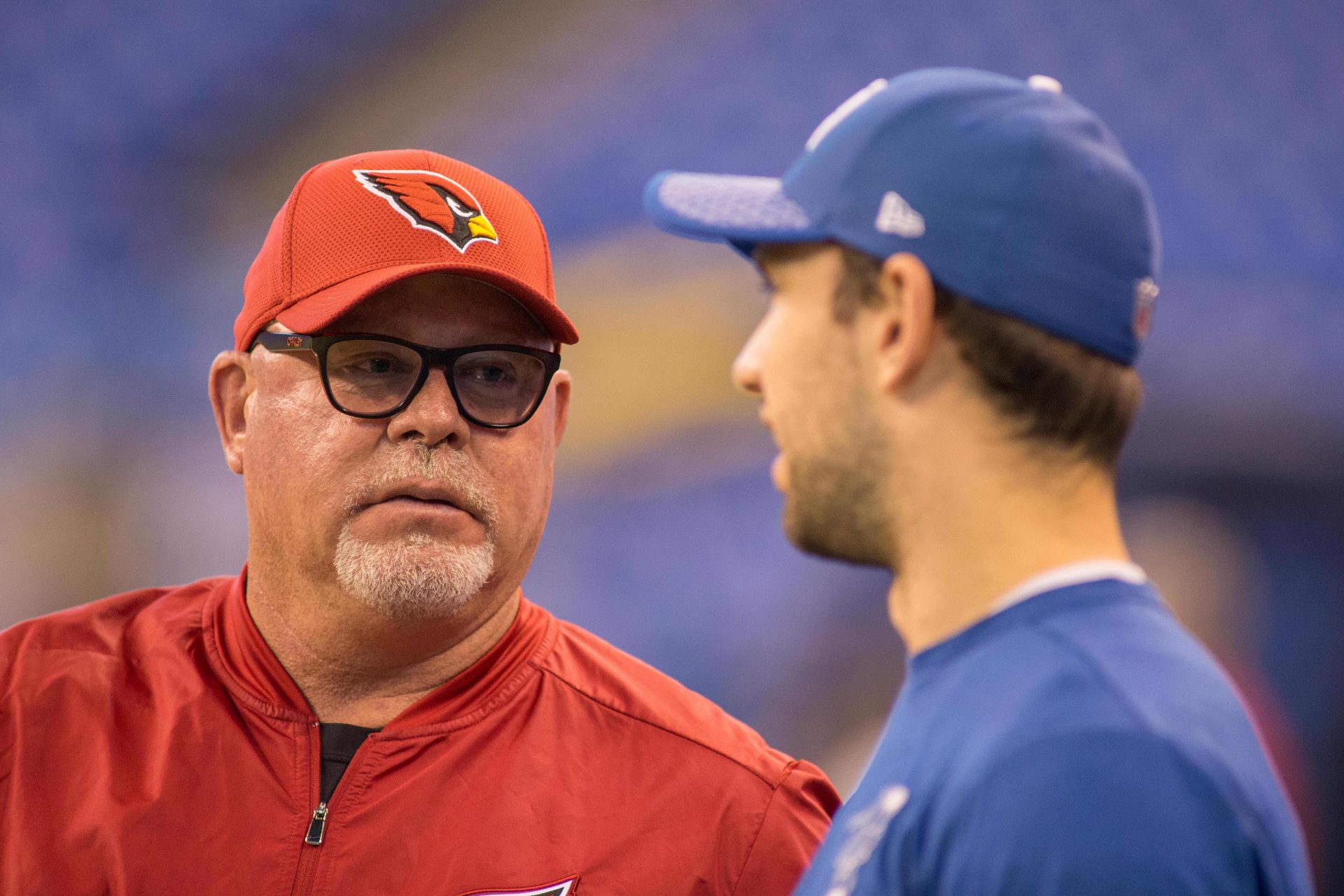 Arizona Cardinals head coach Bruce Arians and Indianapolis Colts quarterback Andrew Luck (12) talk before the game at Lucas Oil Stadium.