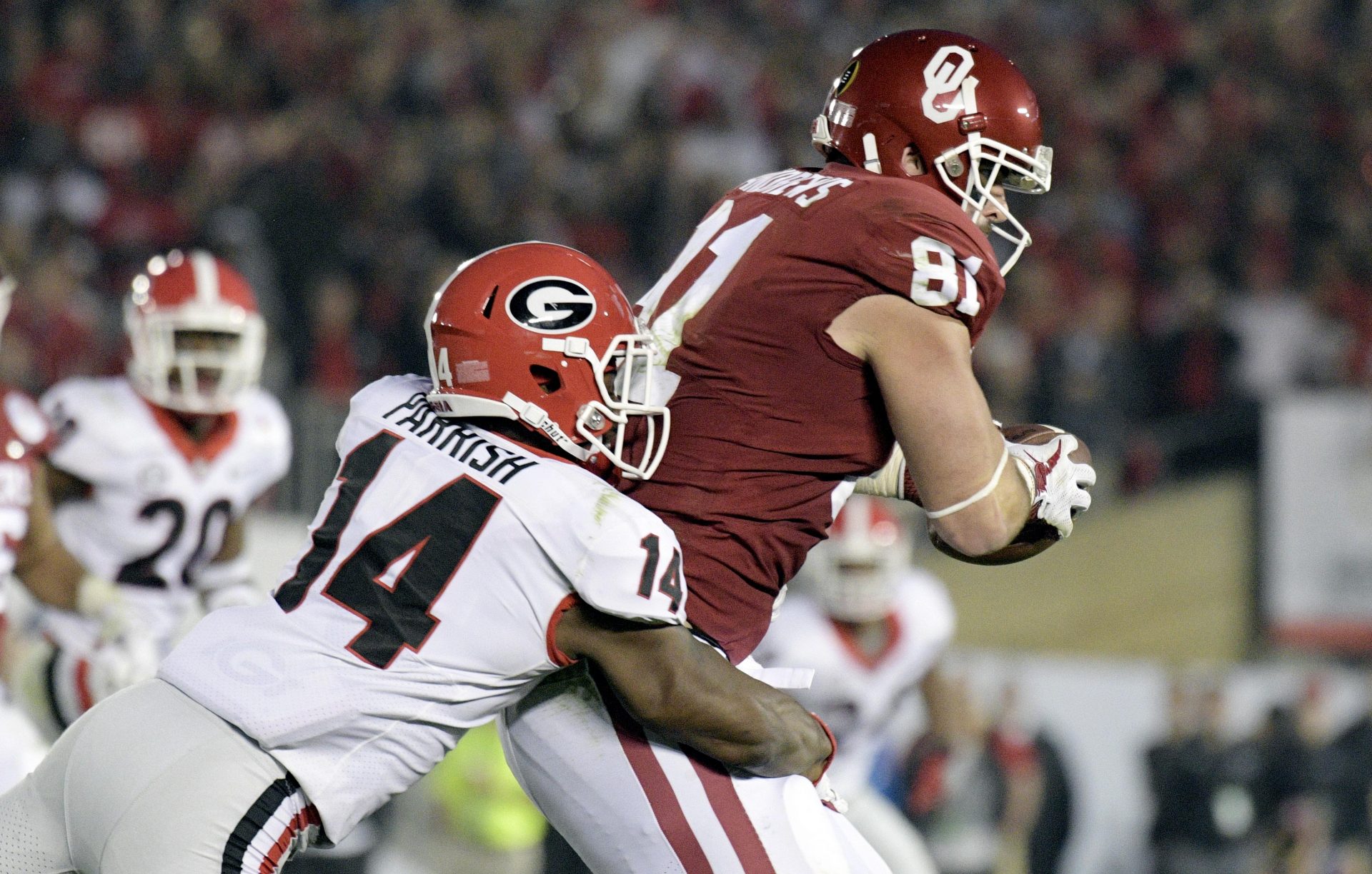 Georgia Bulldogs defensive back Malkom Parrish (14) tackles Oklahoma Sooners tight end Mark Andrews (81) in the fourth quarter in the 2018 Rose Bowl college football playoff semifinal game at Rose Bowl Stadium.