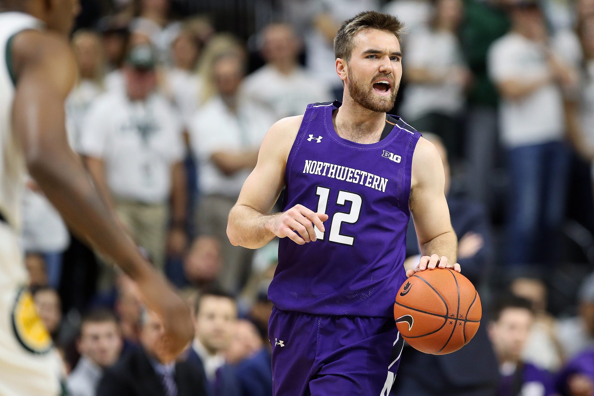 Northwestern Wildcats guard Pat Spencer (12) brings the ball up court during the first half a game against the Michigan State Spartans at the Breslin Center.