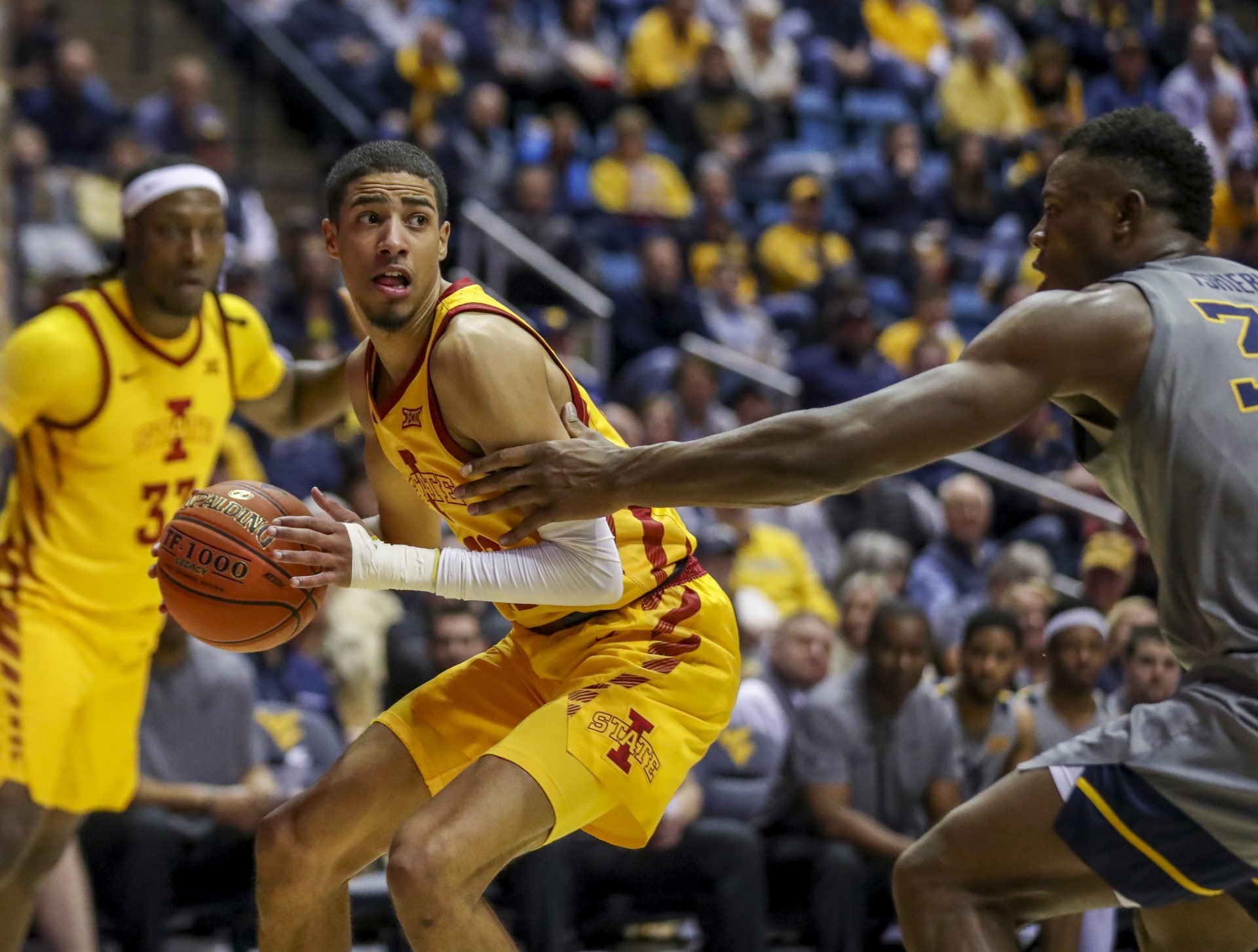 Iowa State Cyclones guard Tyrese Haliburton (22) drives baseline defended by West Virginia Mountaineers forward Oscar Tshiebwe (34) during the first half at WVU Coliseum.