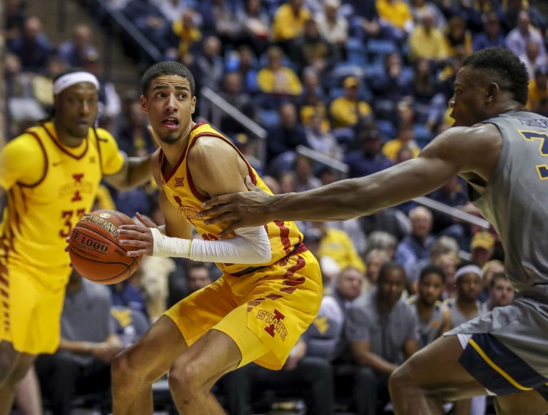 Iowa State Cyclones guard Tyrese Haliburton (22) drives baseline defended by West Virginia Mountaineers forward Oscar Tshiebwe (34) during the first half at WVU Coliseum.