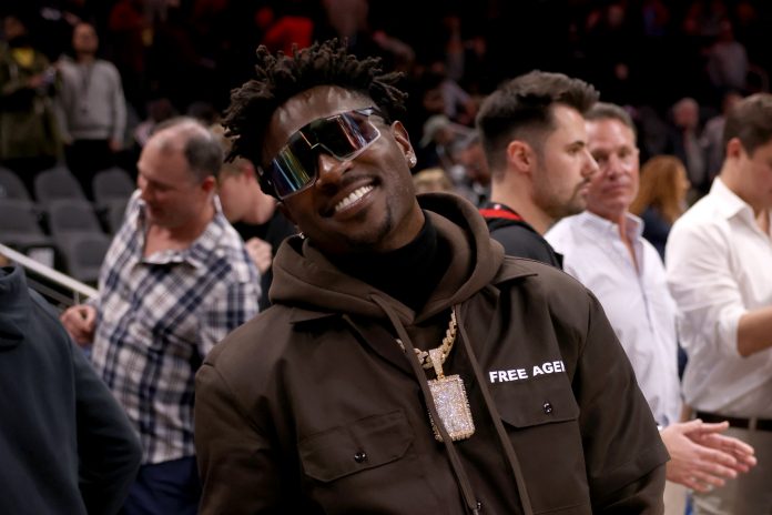 Former Tampa Bay Buccaneers wide receiver Antonio Brown poses for photographers after the game between the Atlanta Hawks and the LA Clippers at State Farm Arena.