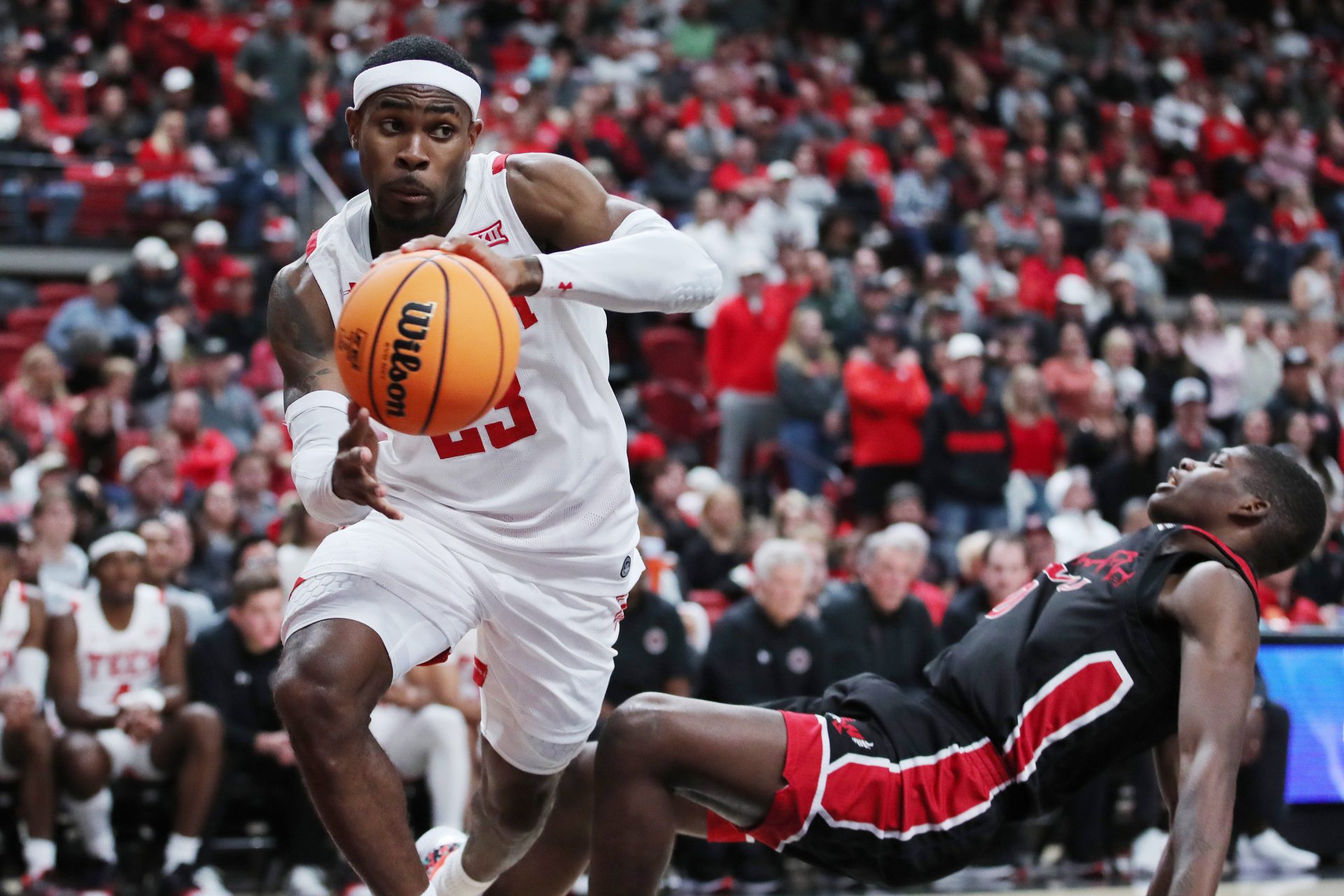 Texas Tech Red Raiders guard DeÕVion Harmon (23) works the ball around Eastern Washington Eagles forward Cedric Coward (0) in the second half at United Supermarkets Arena.