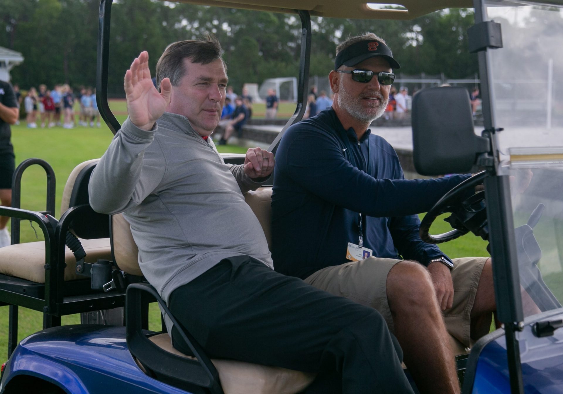 Kirby Smart, Head Coach of the University of Georgia's football program, waves to media gathered at Benjamin High School while riding in a golf cart with Benjamin's Head Football Coach Eric Kresser during a recruiting visit on Wednesday, January 25, 2023, in Palm Beach Gardens, FL.