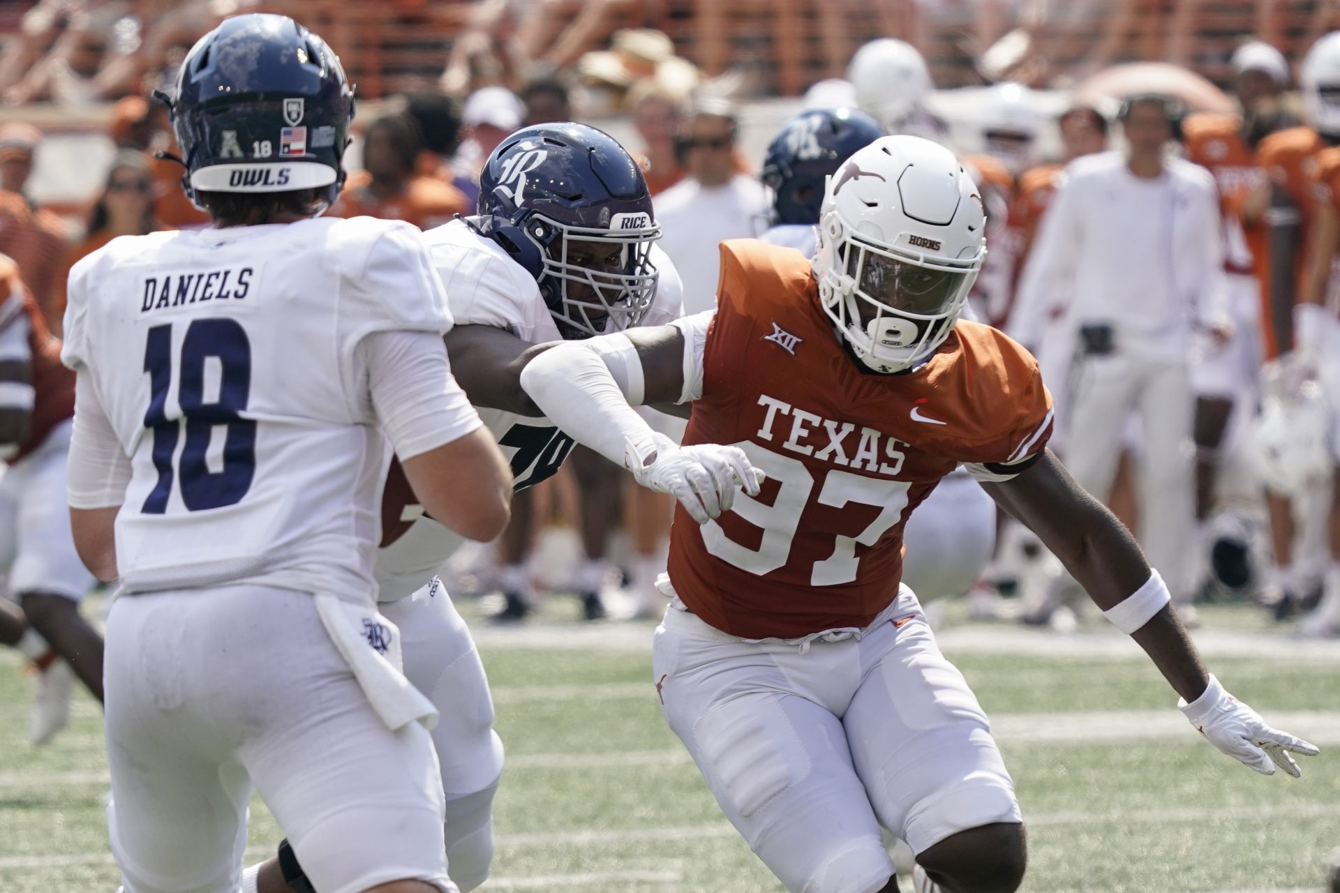 Texas Longhorns  defensive lineman Kristopher Ross (97) rushes quarterback JT Daniels (18) during the first half against the Rice Owls at Darrell K Royal-Texas Memorial Stadium.