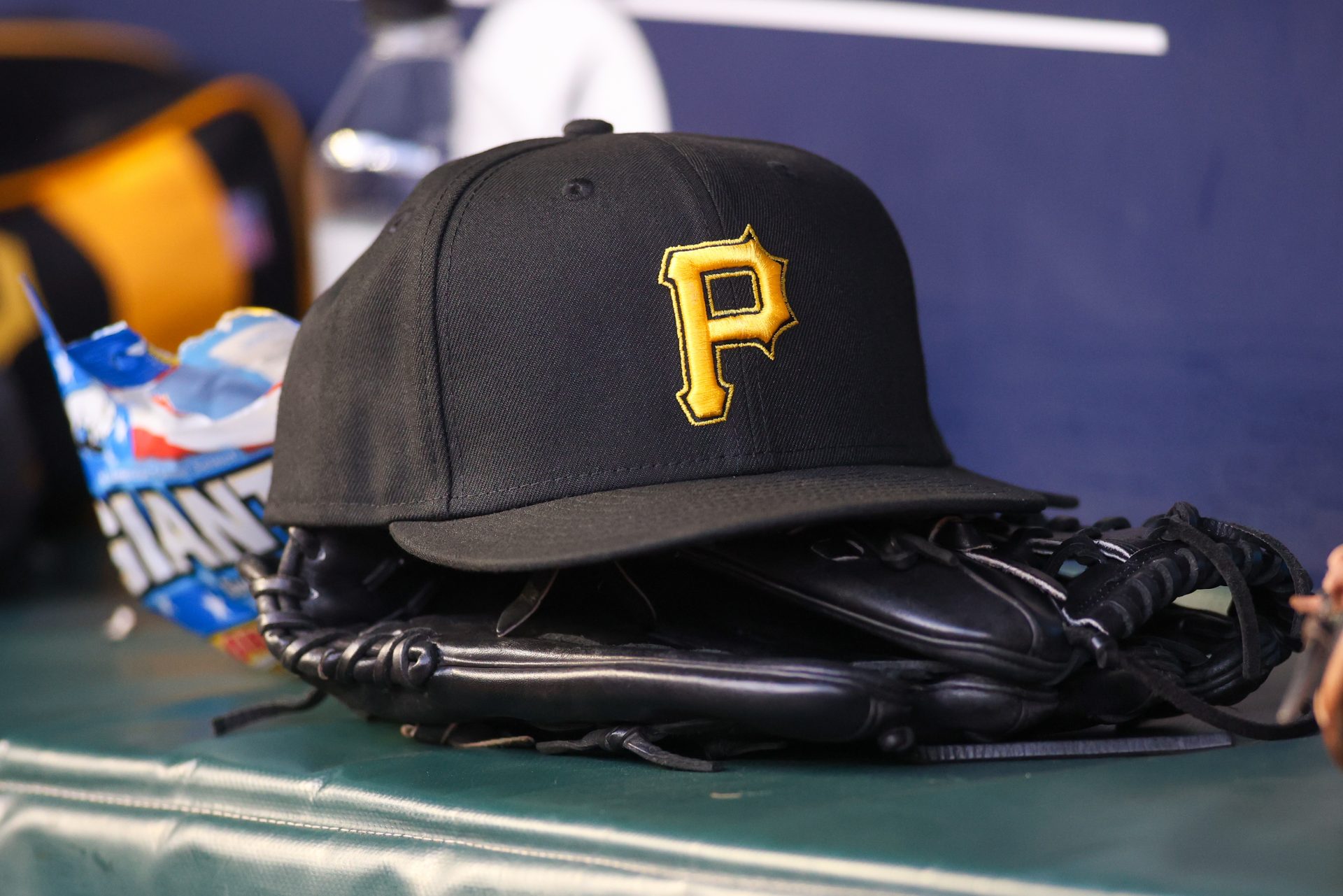A detailed view of a Pittsburgh Pirates hat and glove before a game against the Pittsburgh Pirates in the first inning at Truist Park.