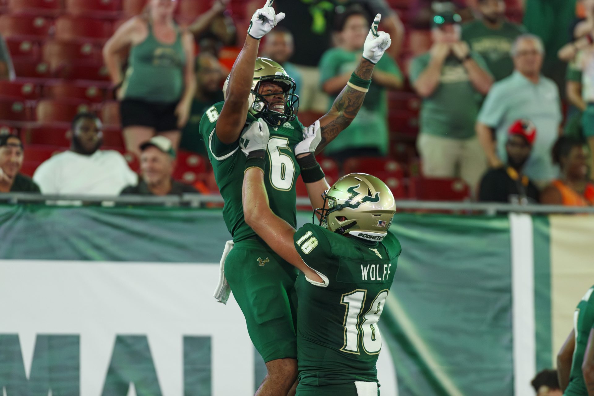 South Florida Bulls Tight end Weston Wolff (18) lifts wide receiver Naiem Simmons (6) after he scored a touchdown during the fourth quarter at Raymond James Stadium.
