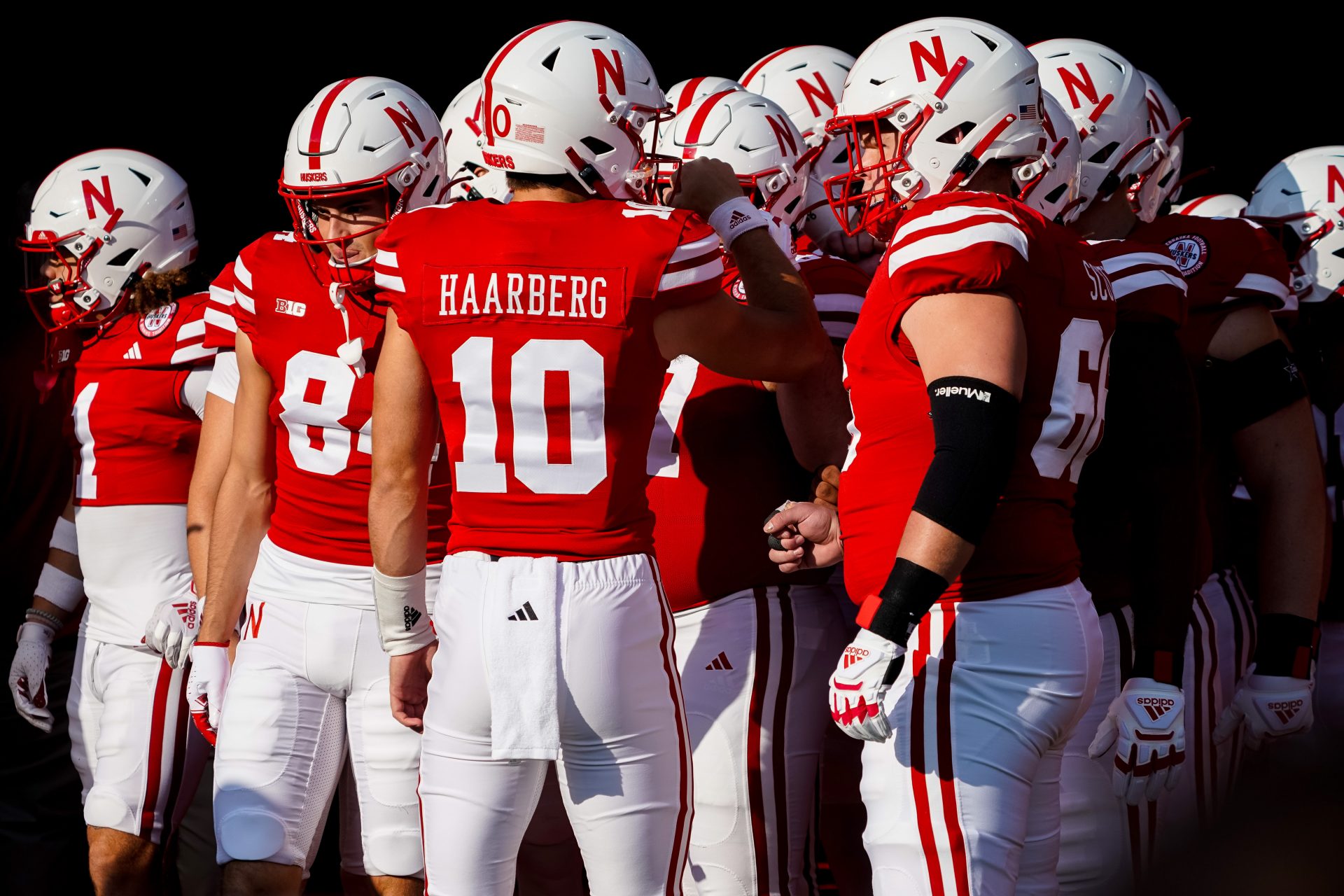 Nebraska Cornhuskers quarterback Heinrich Haarberg (10) huddles with teammates during warmups before the game against the Northern Illinois Huskies at Memorial Stadium.
