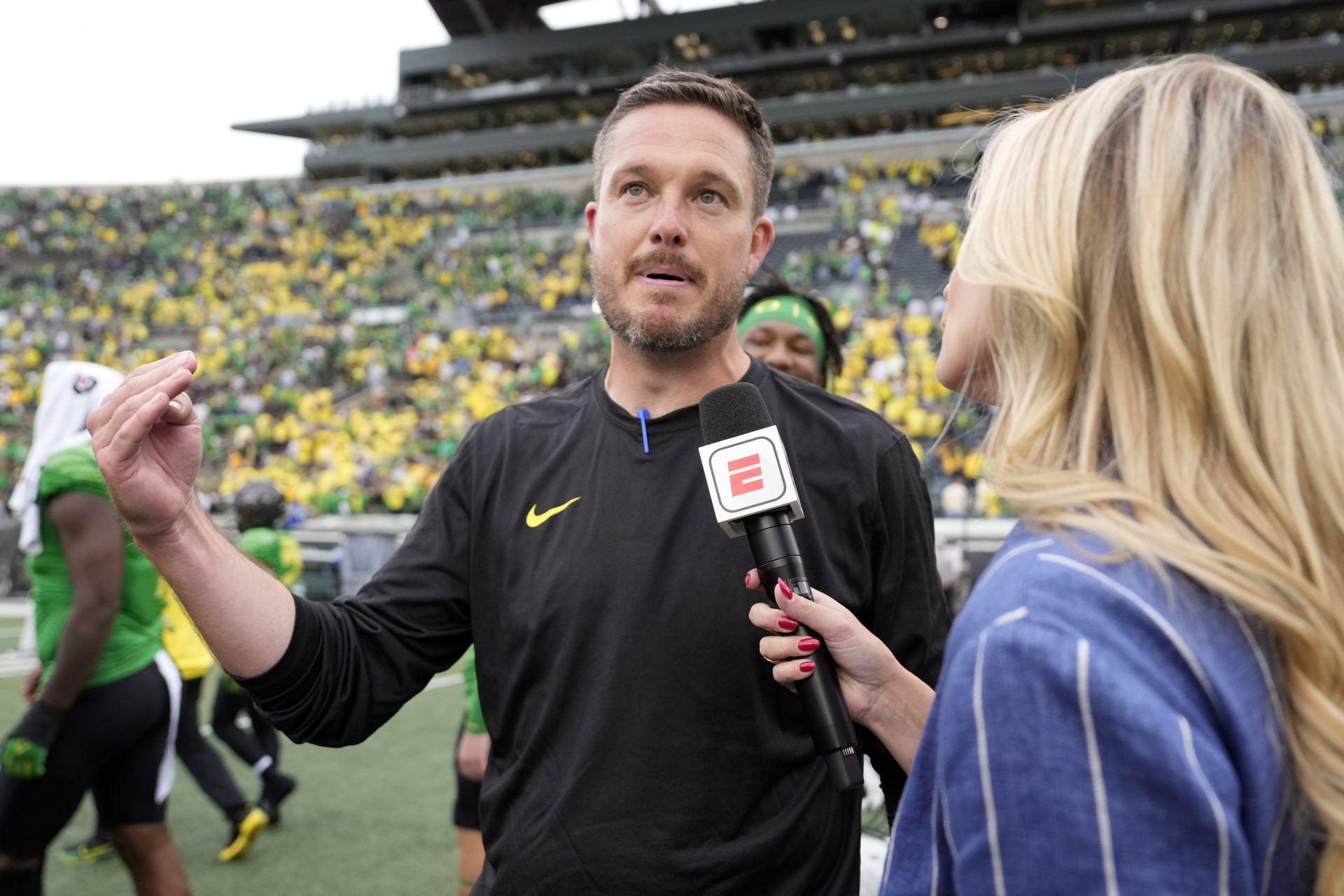 ESPN reporter Katie George interviews Oregon Ducks head coach Dan Lanning after the game at Autzen Stadium.