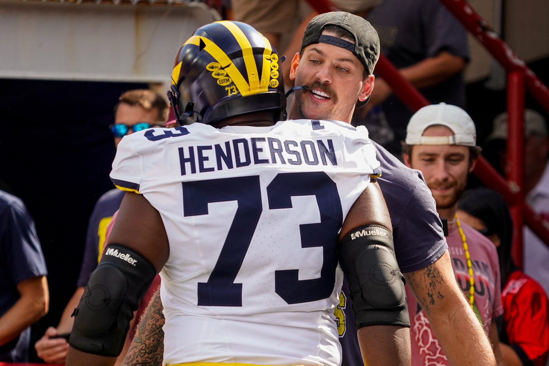 Taylor Lewan greets Michigan Wolverines offensive lineman LaDarius Henderson (73) before the game against the Nebraska Cornhuskers at Memorial Stadium.