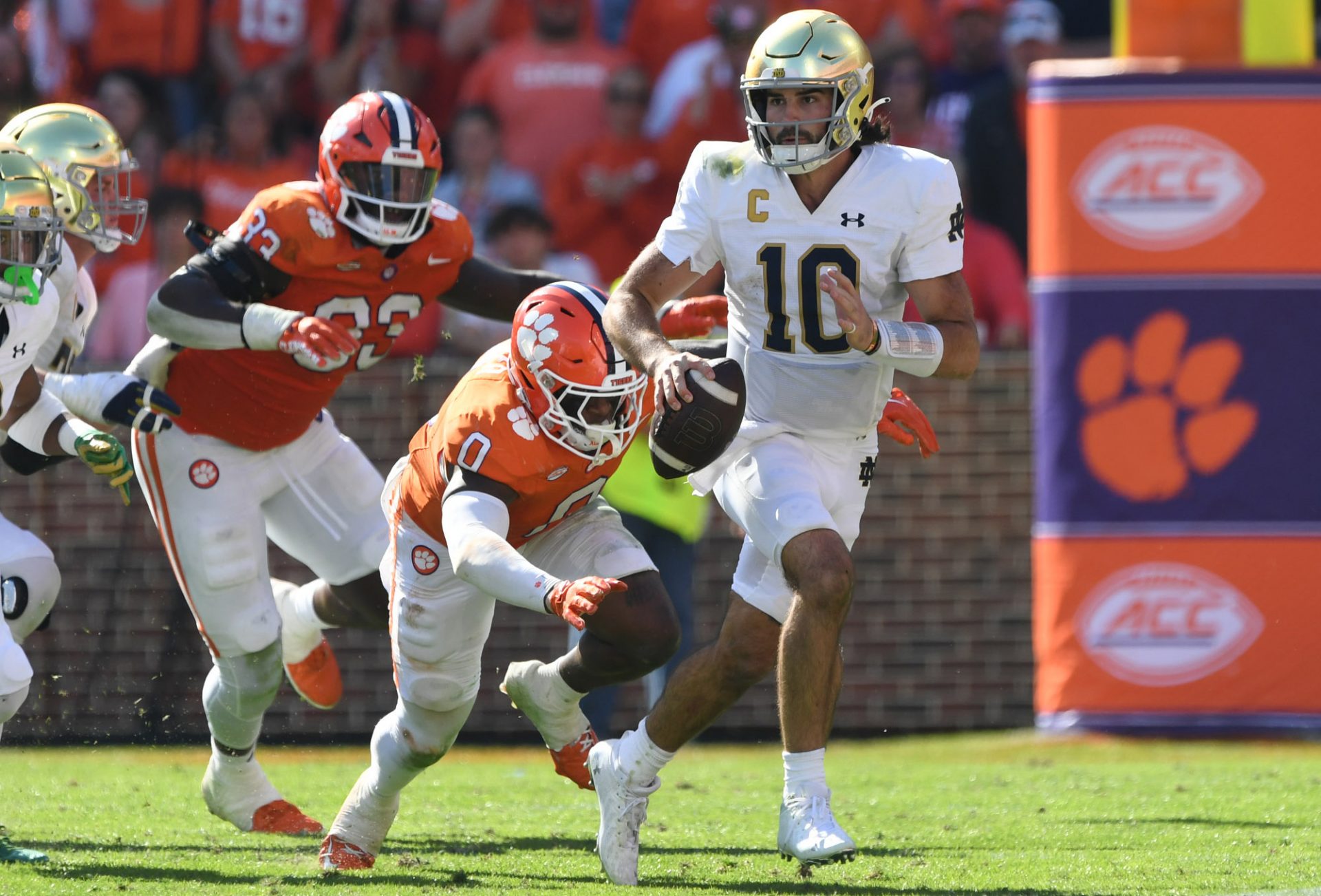 Notre Dame Fighting Irish quarterback Sam Hartman (10) rolls out to throw against Clemson Tigers during the fourth quarter at Memorial Stadium.