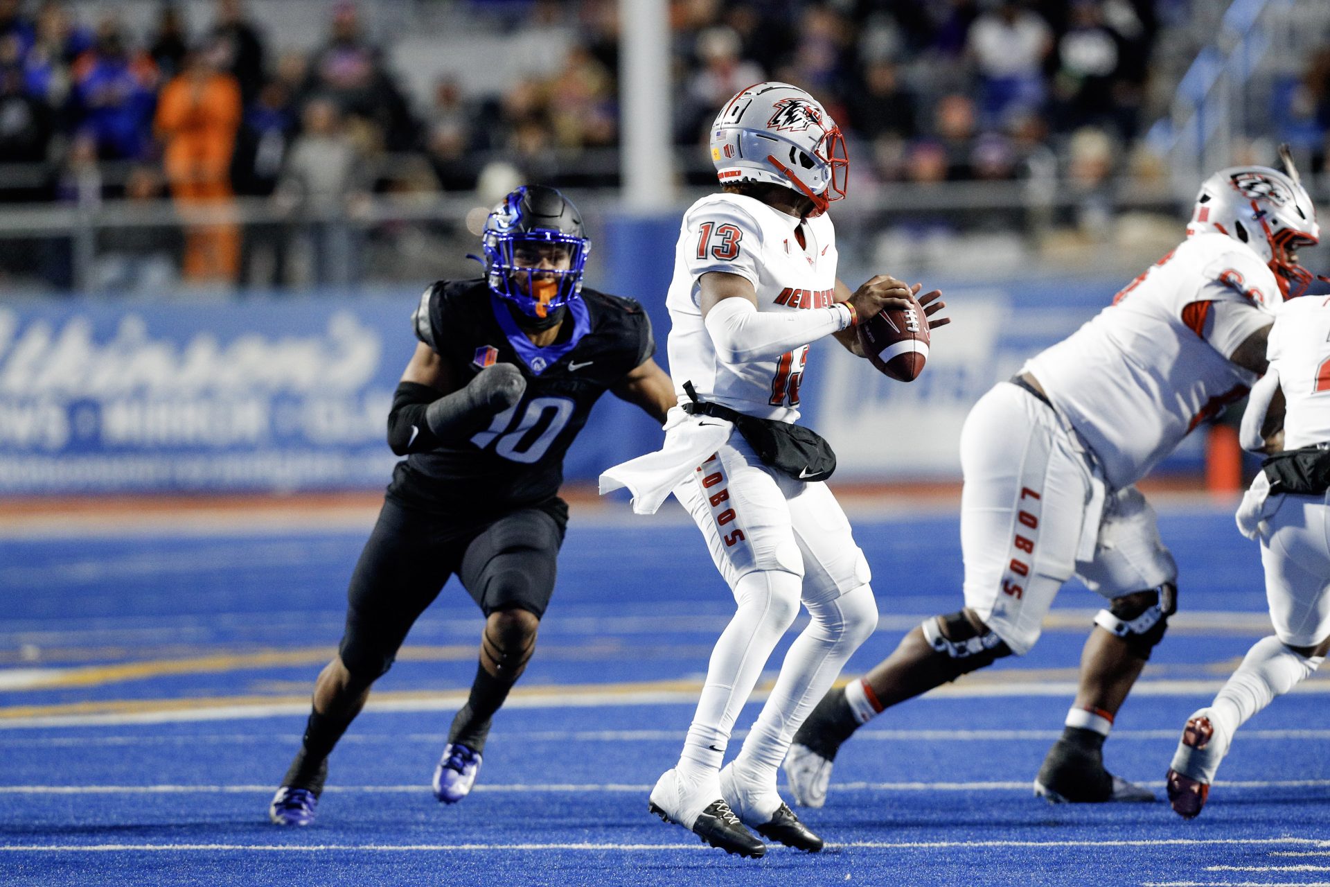 New Mexico Lobos quarterback Devon Dampier (13) is pressured by Boise State Broncos linebacker Andrew Simpson (10) during the second half at Albertsons Stadium. Boise State defeats New Mexico 42-14.