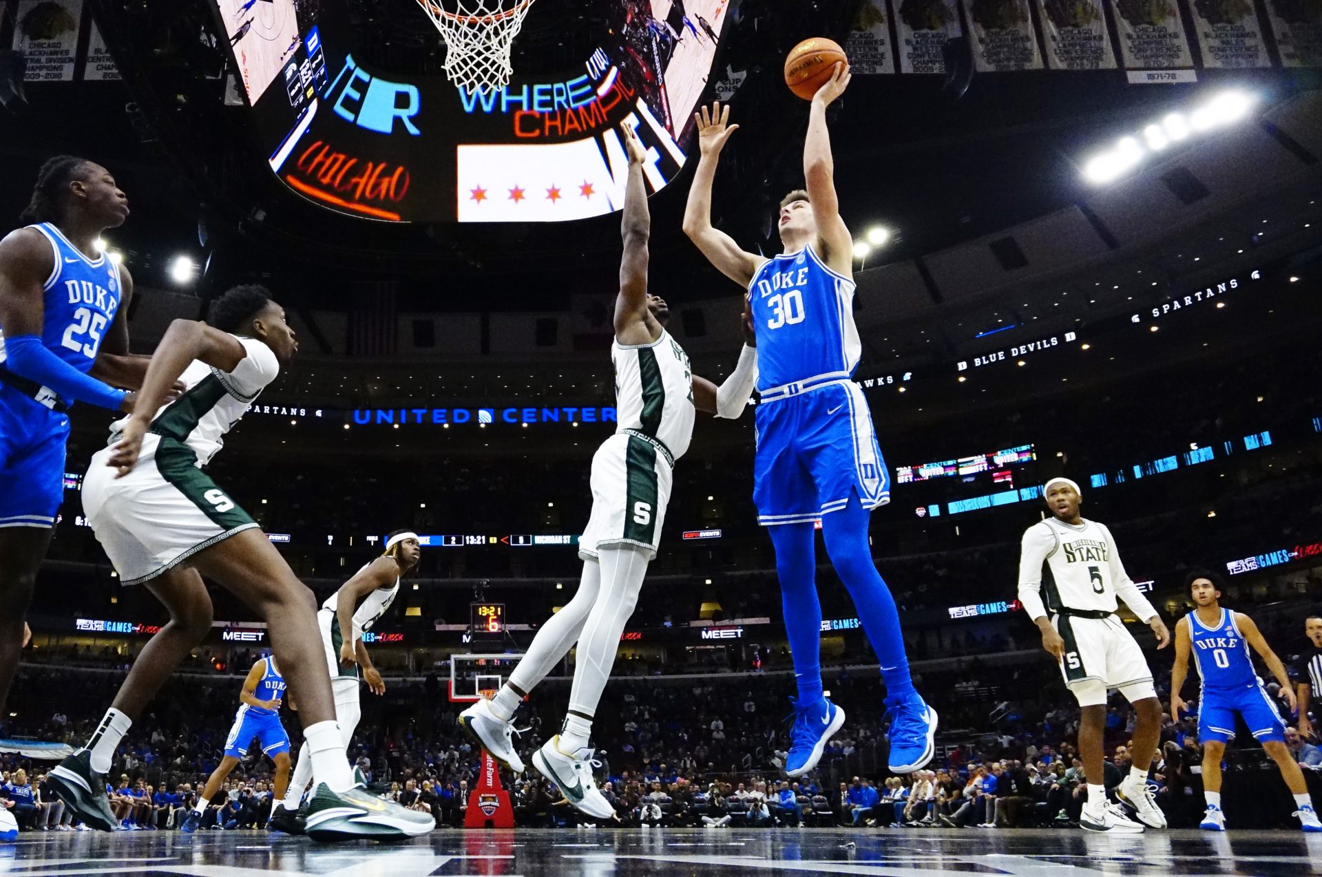 Michigan State Spartans guard Nick Sanders (20) defends Duke Blue Devils center Kyle Filipowski (30) during the first half at United Center.
