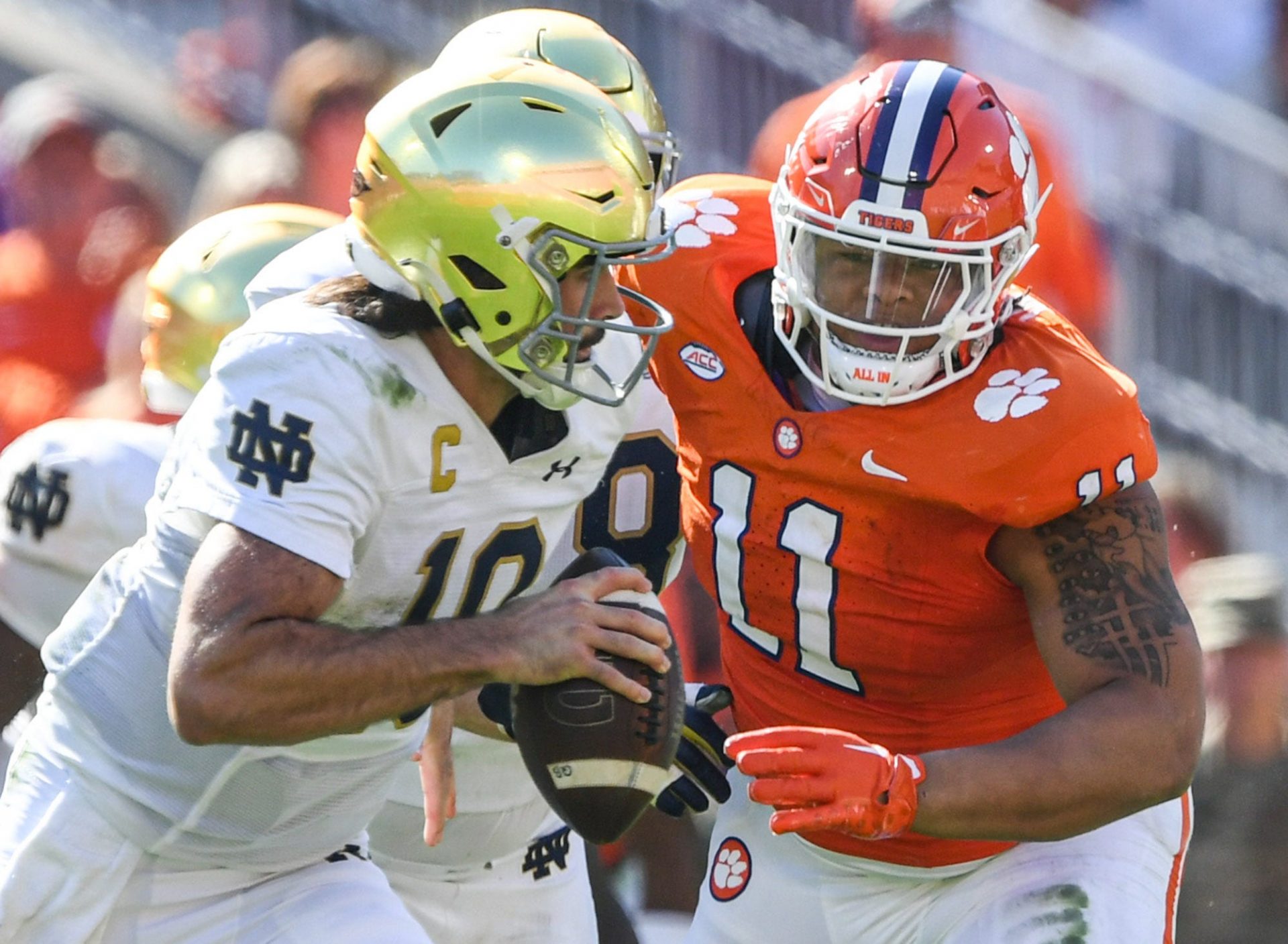 Notre Dame quarterback Sam Hartman (10) runs by Clemson defensive lineman Peter Woods (11) for a touchdown during the third quarter at Memorial Stadium in Clemson, S.C. Saturday, November 4, 2023.