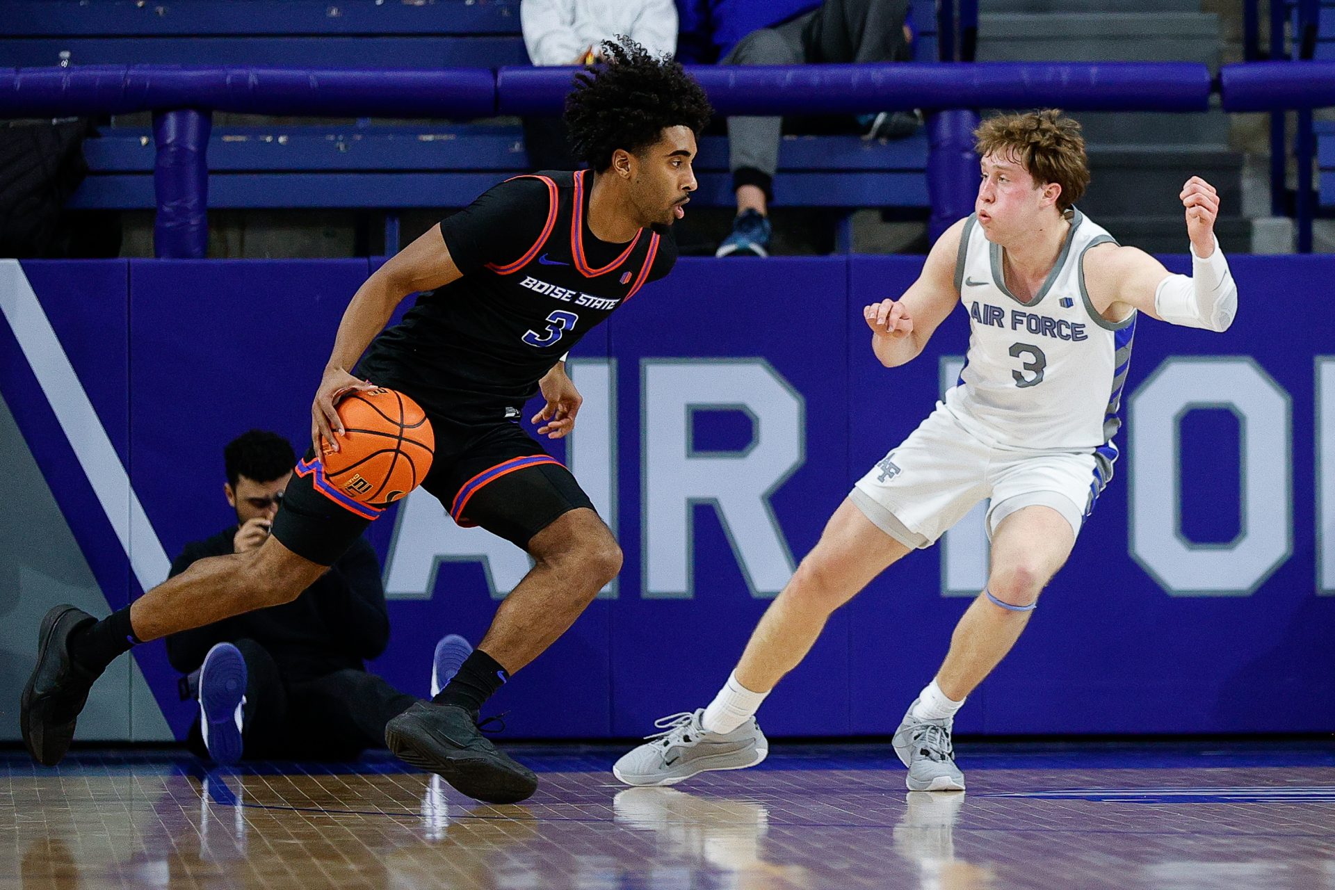 Boise State Broncos guard Kobe Young (3) controls the ball as Air Force Falcons forward Luke Kearney (3) guards in the second half at Clune Arena.