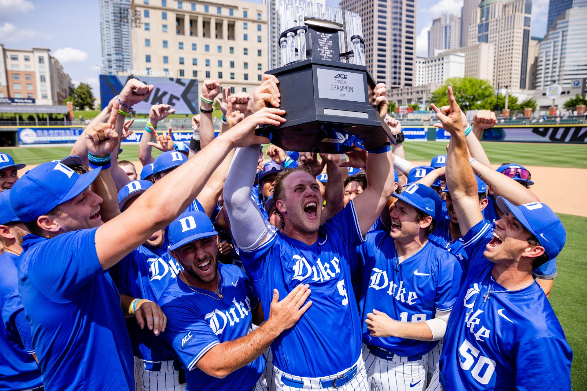 Duke Blue Devils catcher Alex Stone (5) hoists the ACC Championship Trophy after defeating Florida State Seminoles during the ACC Baseball Tournament at Truist Field.