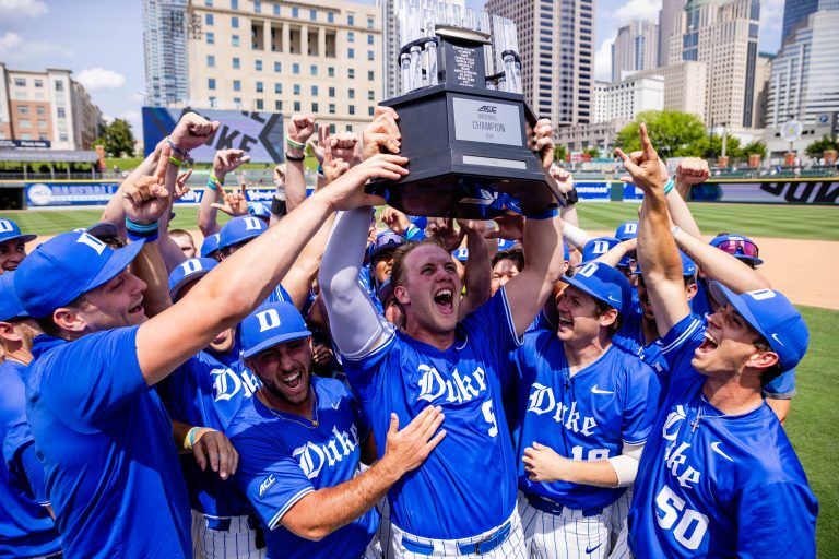 Duke Blue Devils catcher Alex Stone (5) hoists the ACC Championship Trophy after defeating Florida State Seminoles during the ACC Baseball Tournament at Truist Field.