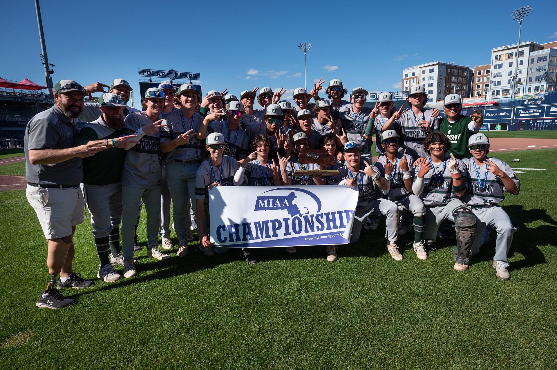Players and coaches from the Oakmont baseball team pose with their trophy and championship banner after defeating St. Mary’s, 3-1, in the D3 State Championship at Polar Park in Worcester on Saturday June 15, 2024.