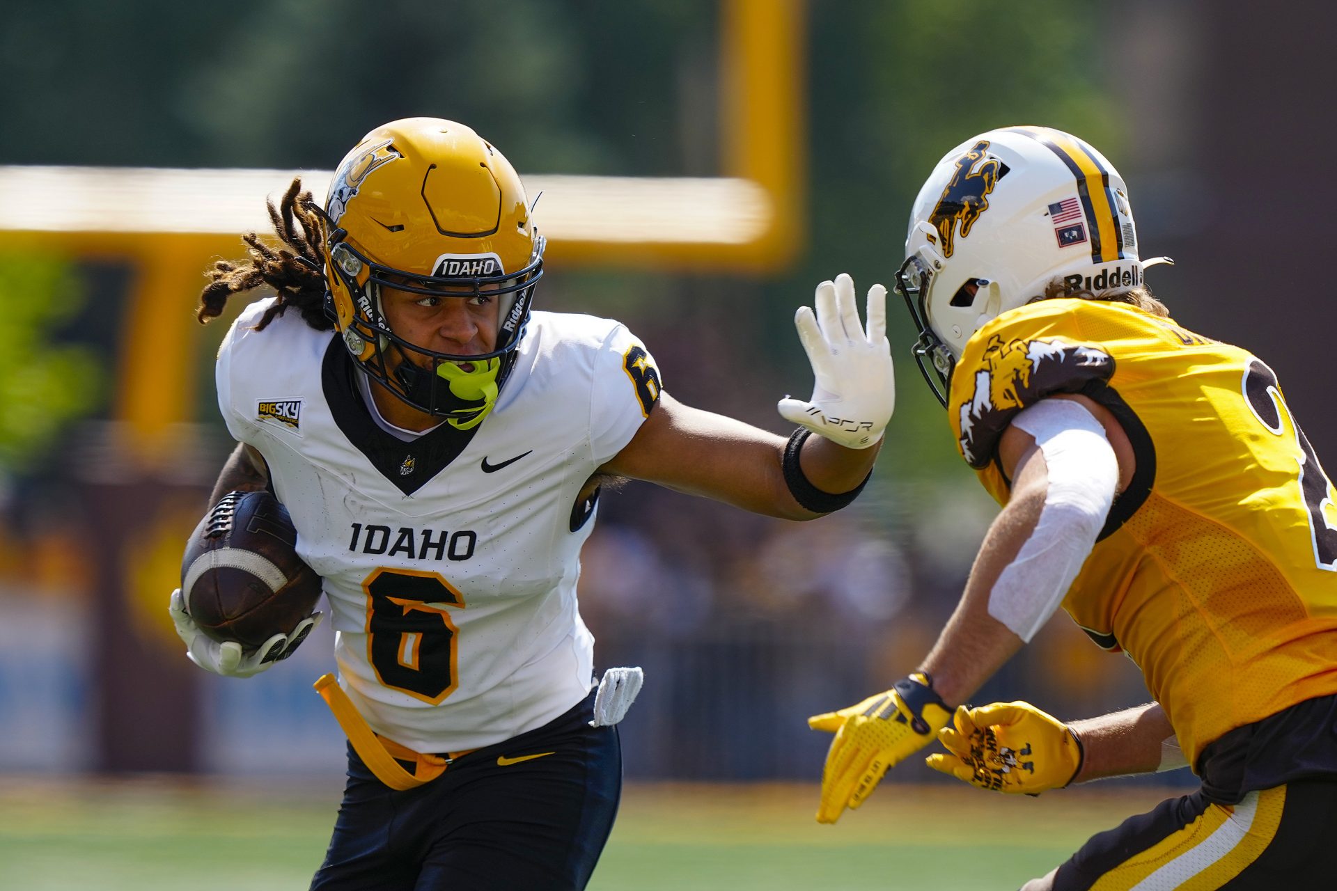 Idaho Vandals wide receiver Jordan Dwyer (6) stiff arms Wyoming Cowboys nose guard Wrook Brown (2) during the first quarter at Jonah Field at War Memorial Stadium.