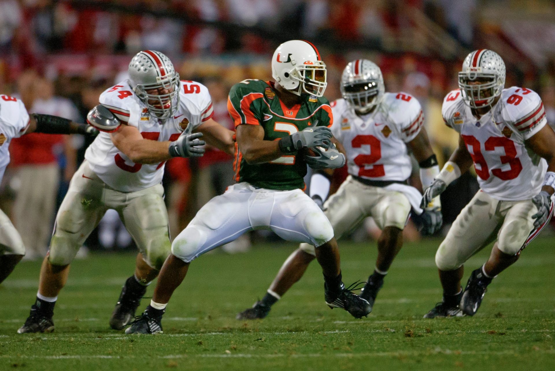 Willis McGahee of Miami faces the OSU defense of Cie Grant (6), Tim Anderson (54), Michael Doss (2) and Will Smith (93).