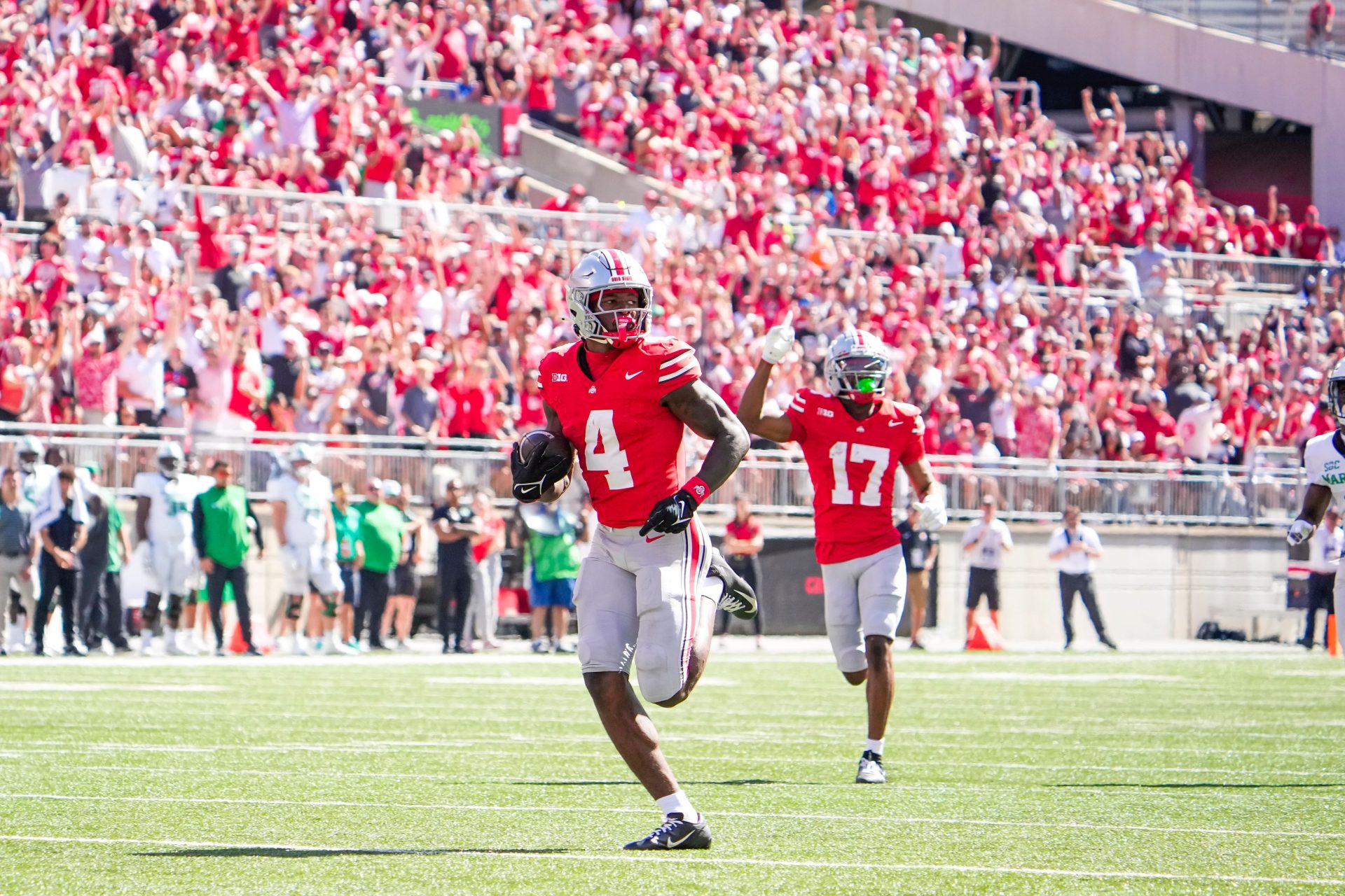 Ohio State Buckeyes wide receiver Jeremiah Smith (4) runs the ball in for a touchdown against the Marshall Thundering Herd in the second half at Ohio Stadium on Saturday.