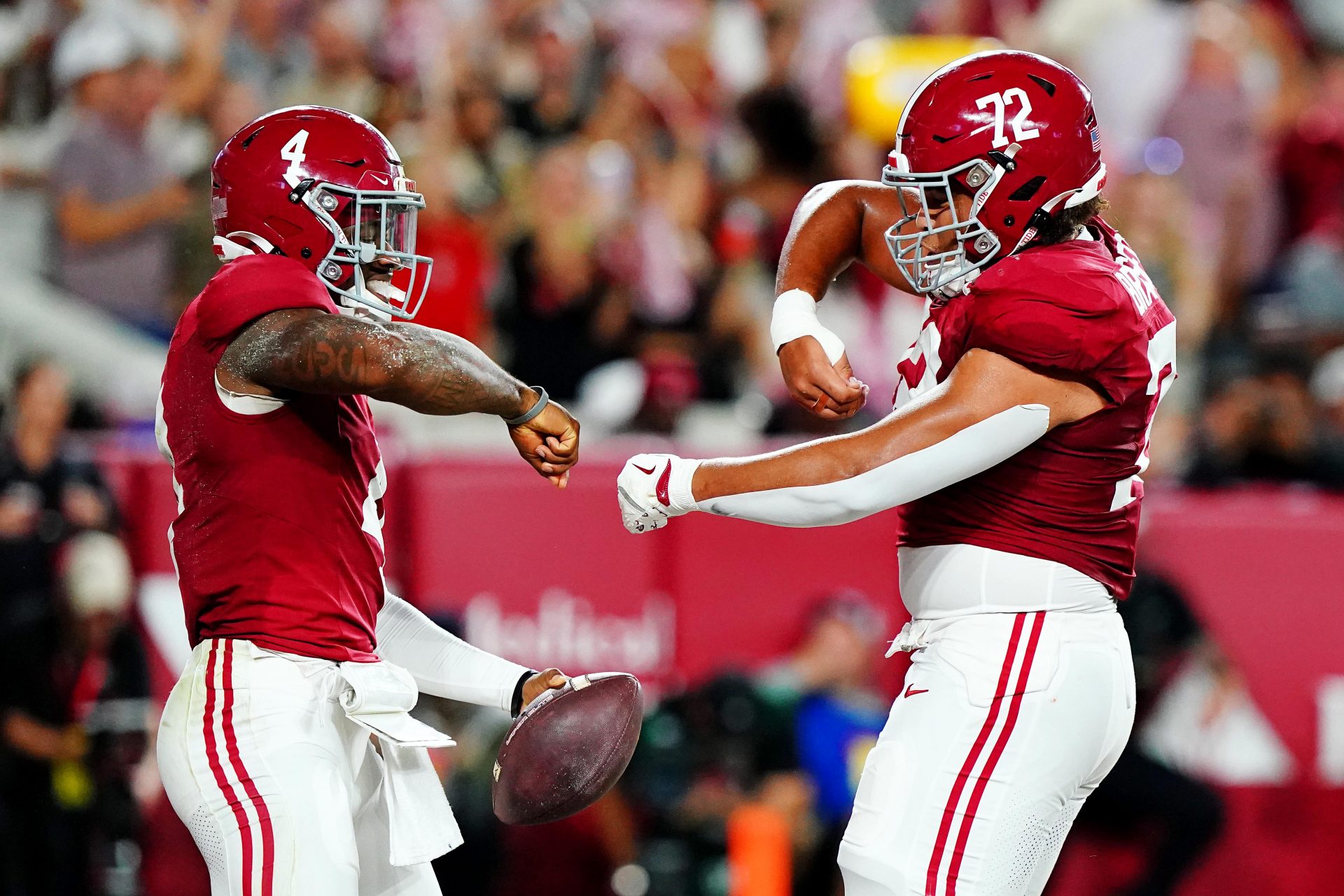 Alabama Crimson Tide quarterback Jalen Milroe (4) celebrates with offensive lineman Parker Brailsford (72) after scoring a touchdown during the first quarter against the Georgia Bulldogs at Bryant-Denny Stadium.
