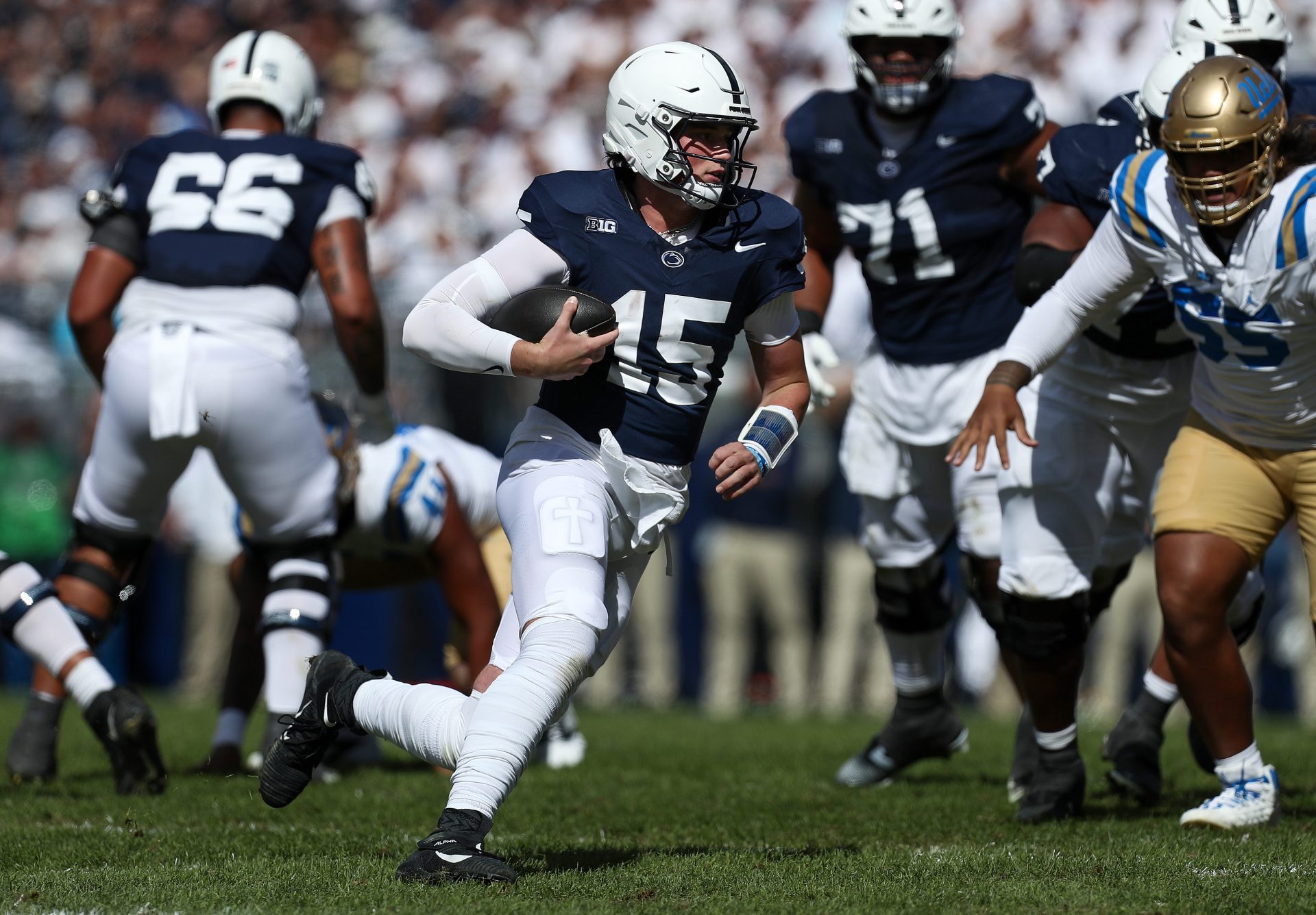 Penn State Nittany Lions quarterback Drew Allar (15) runs with the ball during the second quarter against the UCLA Bruins at Beaver Stadium.