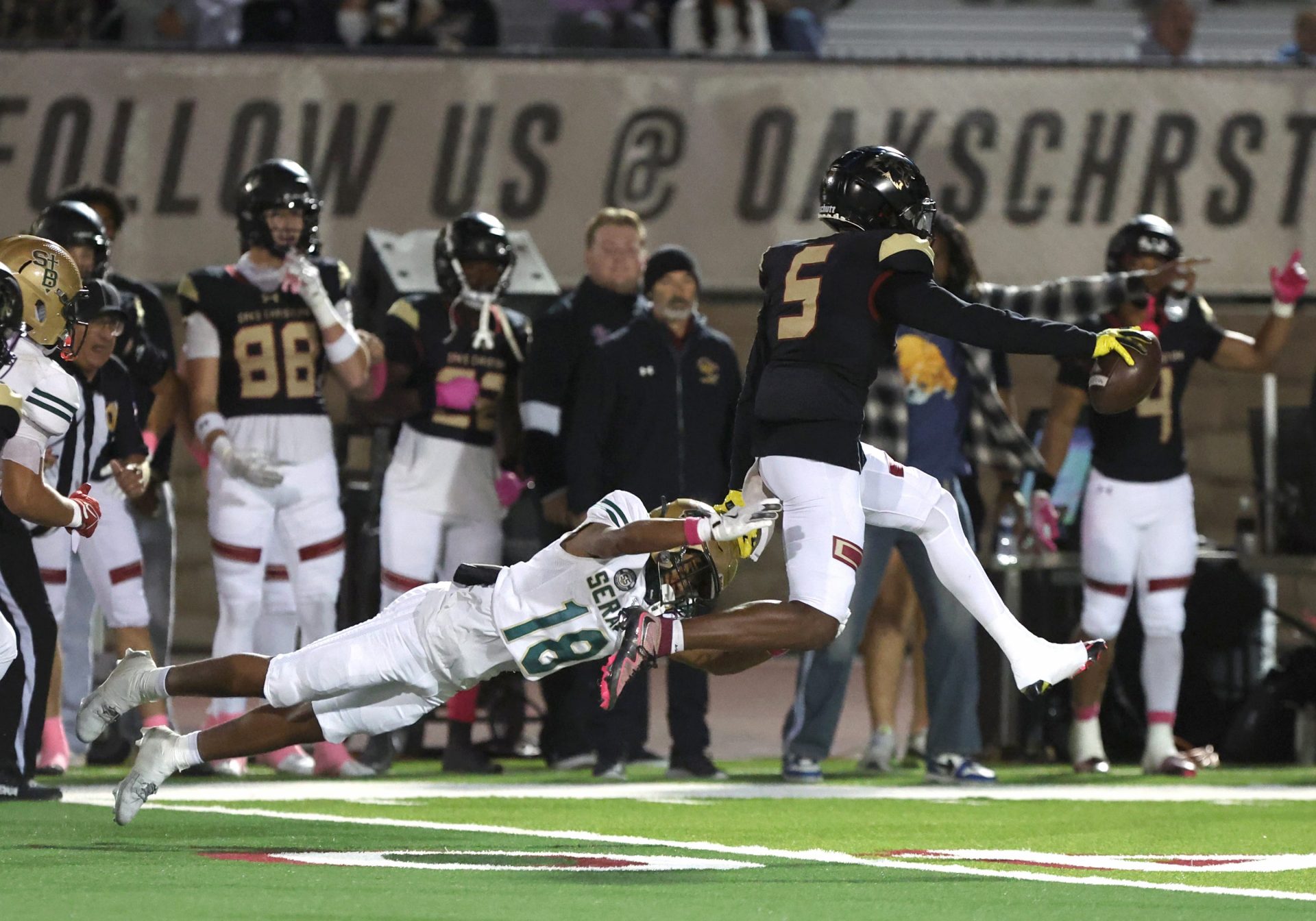 Oaks Christian's Davon Benjamin leaps free from St. Bonaventure's Darrien Johnson return an interception for a touchdown in the third quarter of Oaks Christian's win over visiting St. Bonaventure Friday at Redell Field. The Lions won, 35-0.