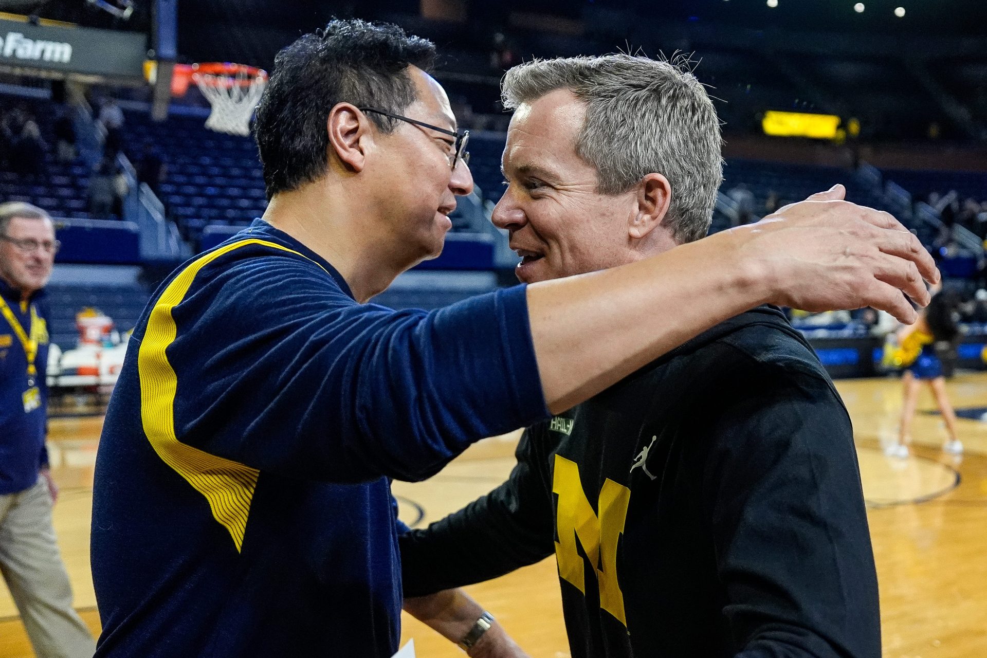 Michigan head coach Dusty May, right, is congratulated by U-M president Santa Ono after 101-53 win over Cleveland State at Crisler Center in Ann Arbor on Monday, Nov. 4, 2024.