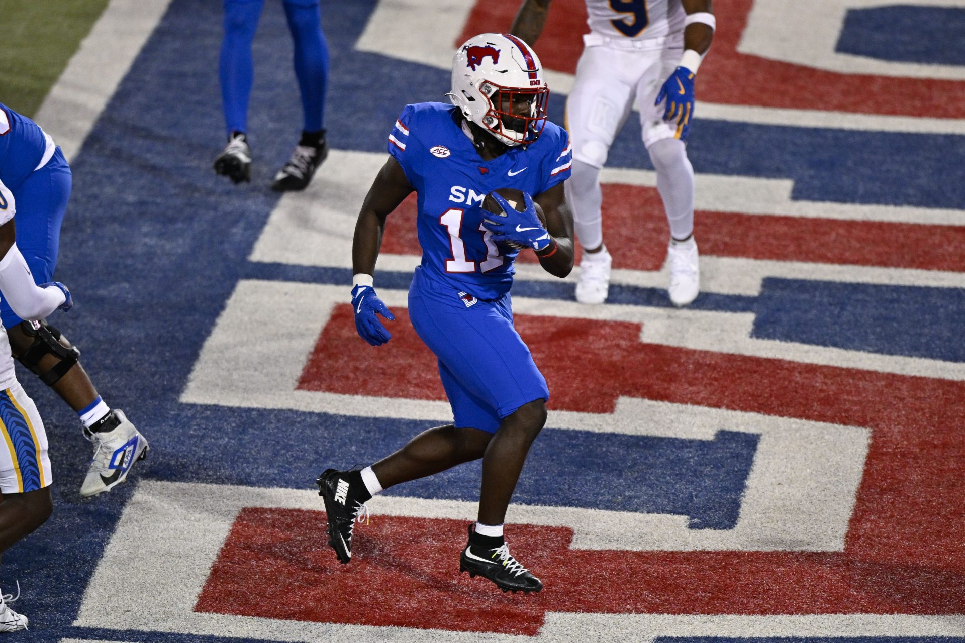 Southern Methodist Mustangs running back LJ Johnson Jr. (11) scores a touchdown during the game between the Southern Methodist Mustangs and the Pittsburgh Panthers at Gerald J. Ford Stadium.