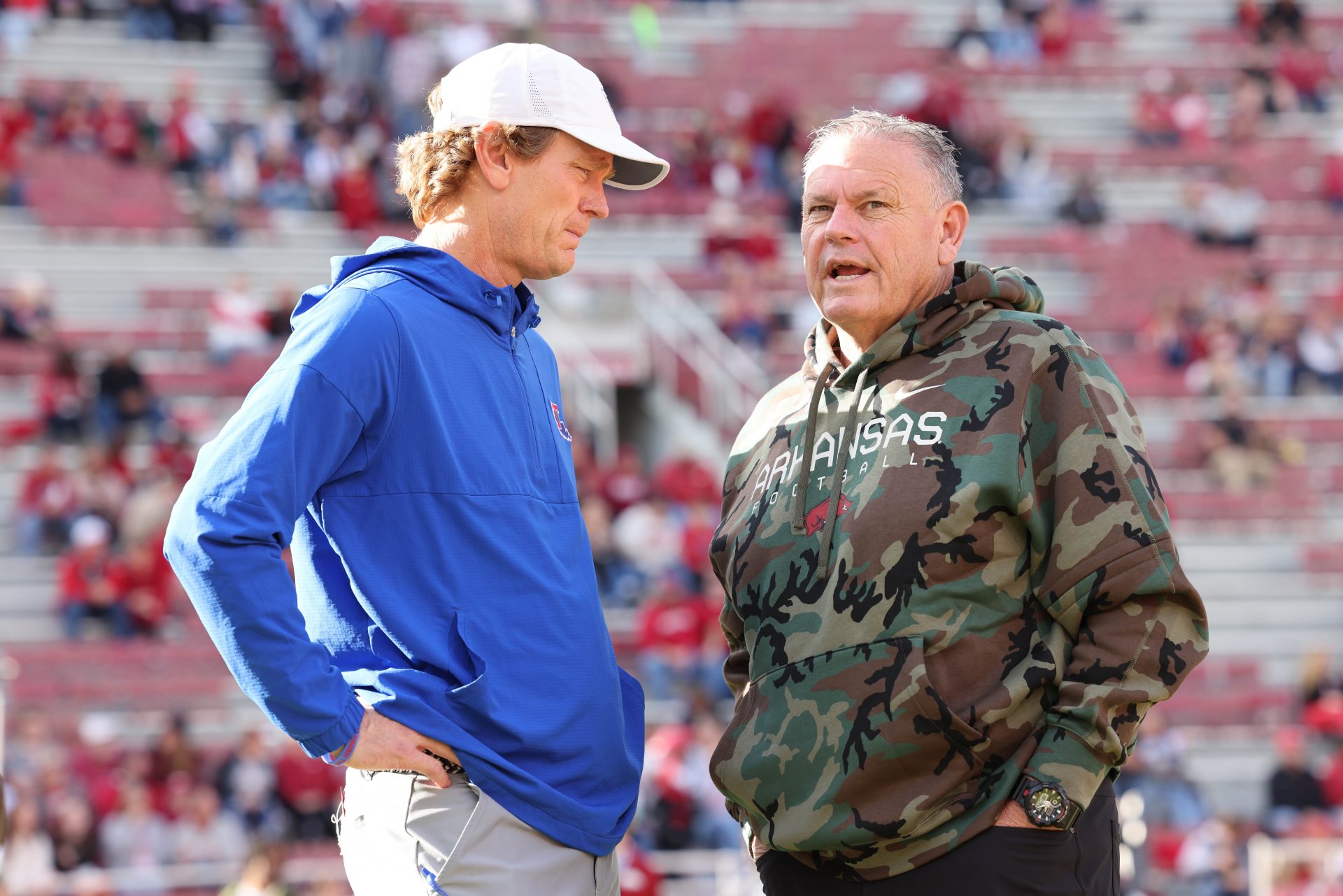 Louisiana Tech Bulldogs head coach Sonny Crumbie talks to Arkansas Razorbacks head coach Sam Pittman prior to a game at Donald W. Reynolds Razorback Stadium.