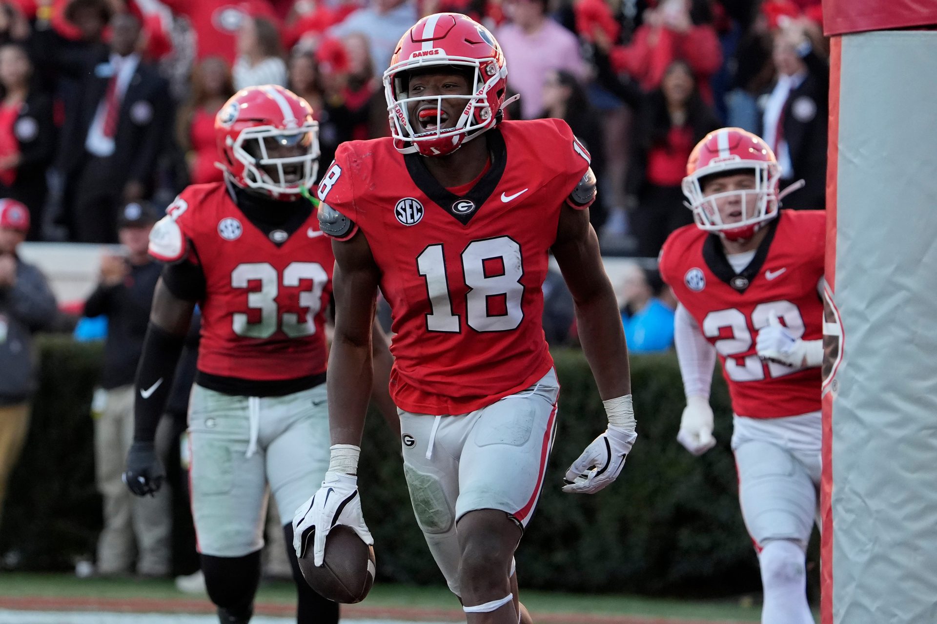 Georgia linebacker Chris Cole (18) celebrates with his teammates after scoring touchdown during the second half of a NCAA college football game against Massachusetts in Athens, Ga., on Saturday, Nov. 23, 2024.