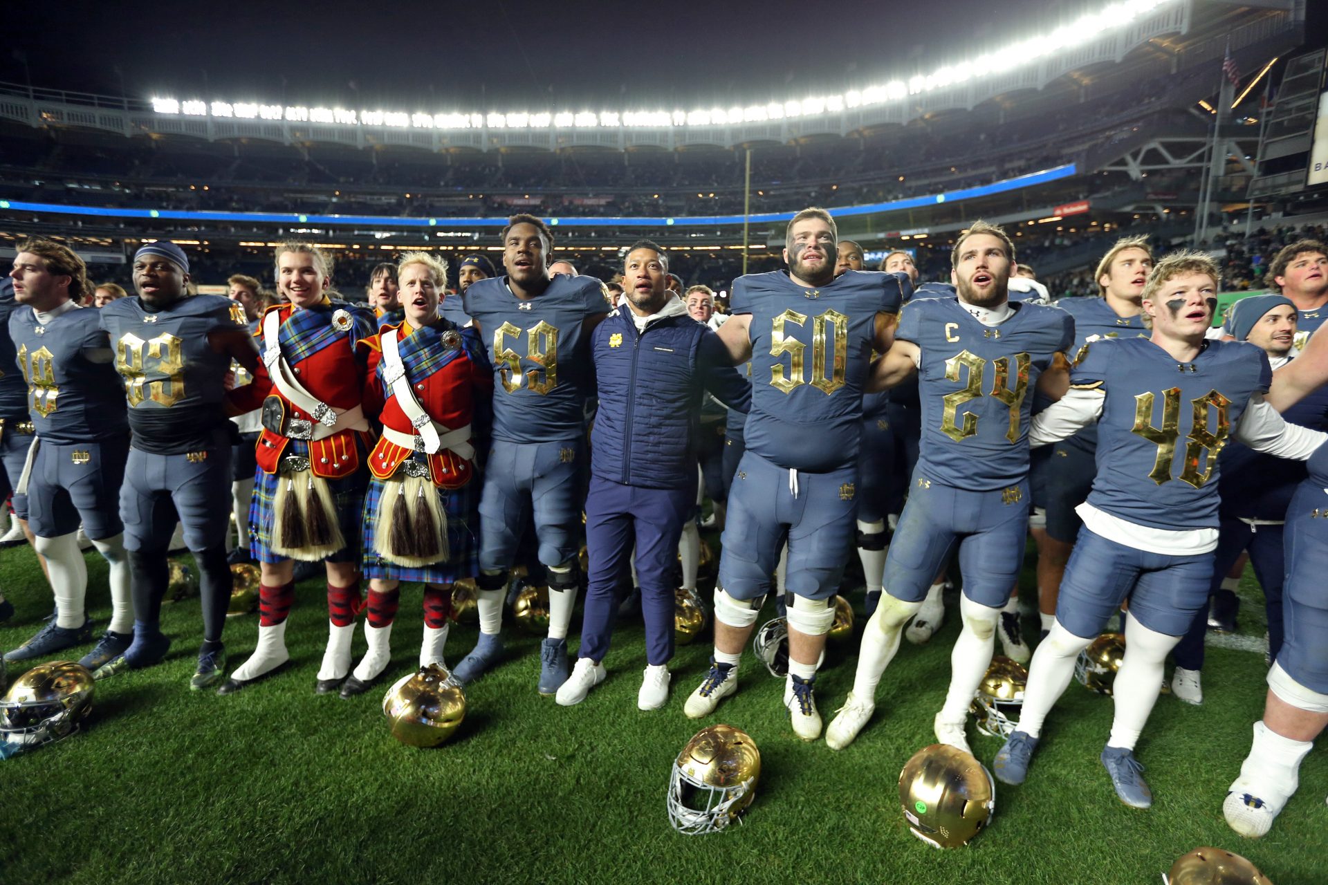 Notre Dame Fighting Irish head coach Marcus Freeman and his players sing the Notre Dame alma mater after a win against the Army Black Knights at Yankee Stadium.