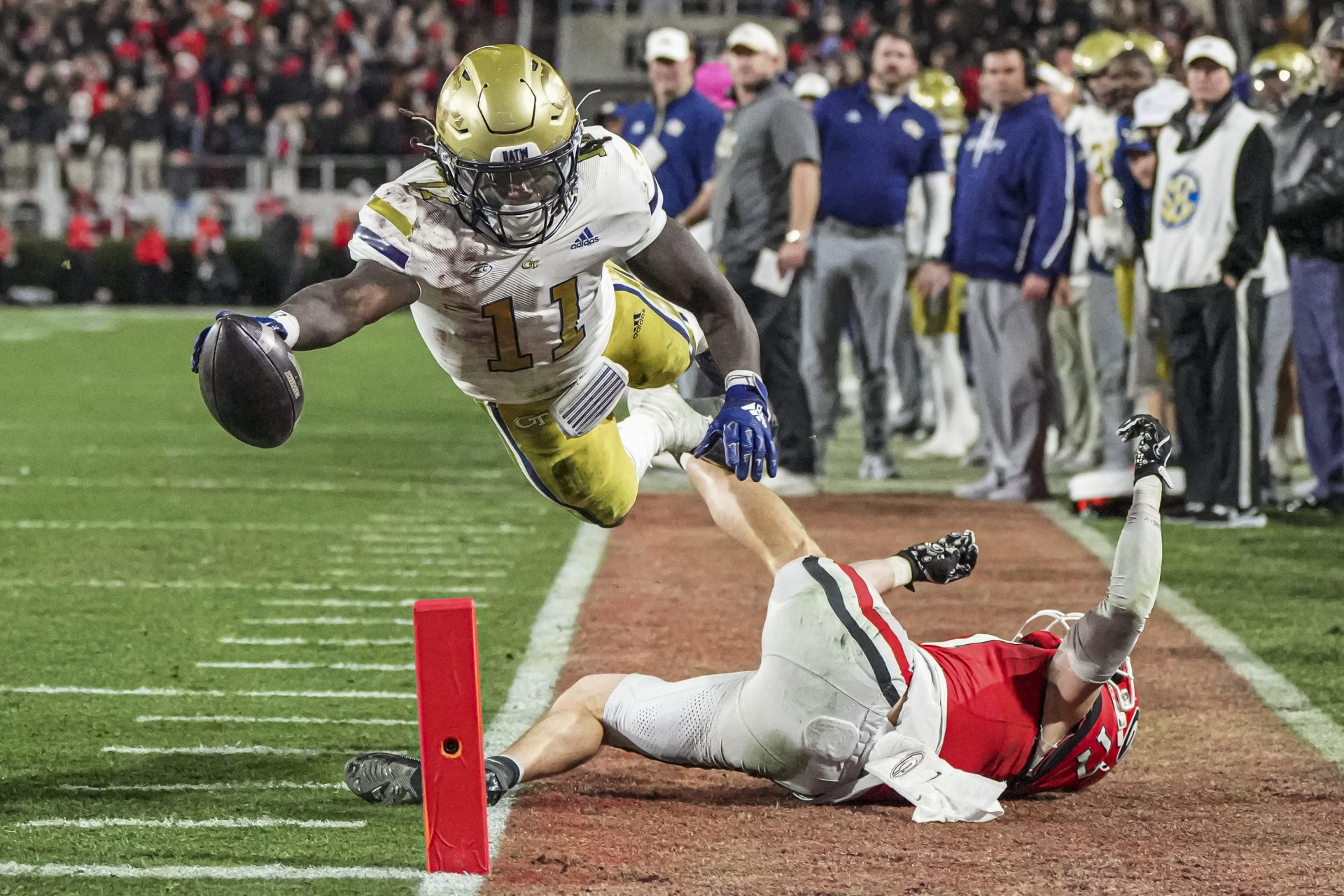 Georgia Tech Yellow Jackets running back Jamal Haynes (11) scores a touchdown past Georgia Bulldogs defensive back Dan Jackson (17) during the first half at Sanford Stadium.
