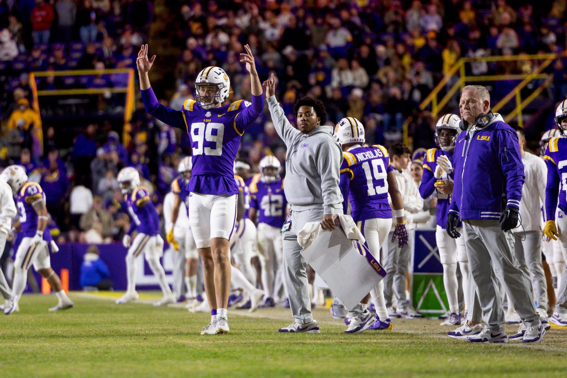 LSU Tigers defensive tackle Gio Paez (99) and head coach Brian Kelly react to a field goal made against the Oklahoma Sooners during the fourth quarter at Tiger Stadium.