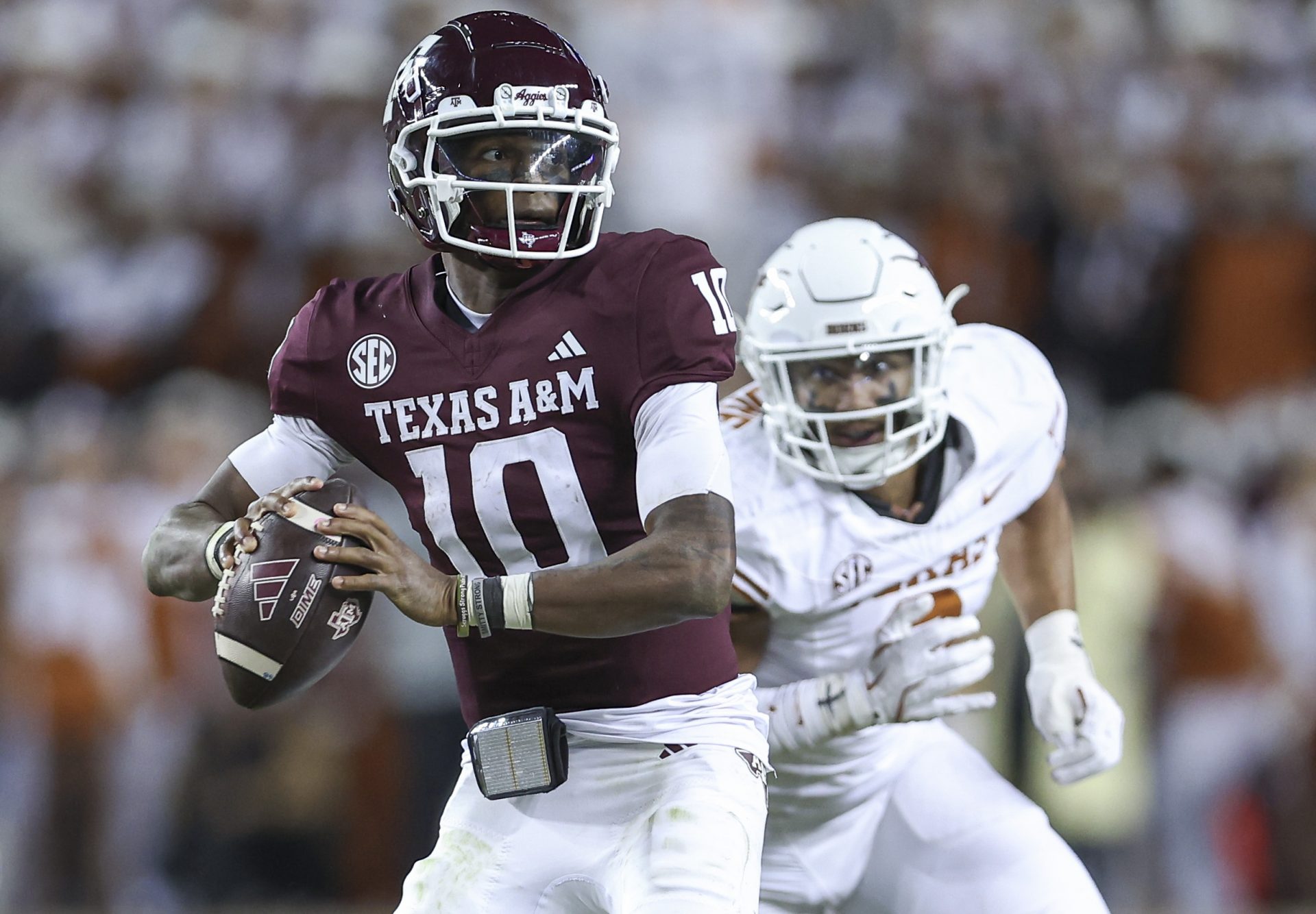 Texas A&M Aggies quarterback Marcel Reed (10) looks for an open receiver as Texas Longhorns linebacker Trey Moore (8) defends during the fourth quarter at Kyle Field.