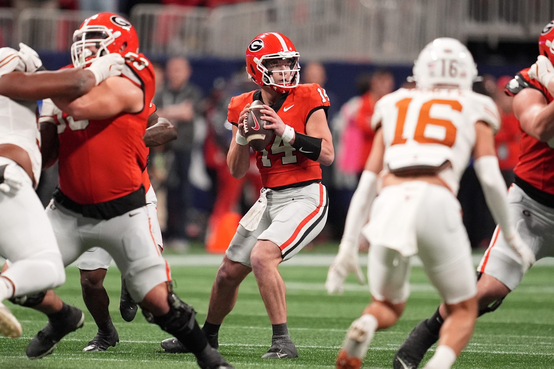 Georgia Bulldogs quarterback Gunner Stockton (14) drops back to pass against the Texas Longhorns during the second half in the 2024 SEC Championship game at Mercedes-Benz Stadium.