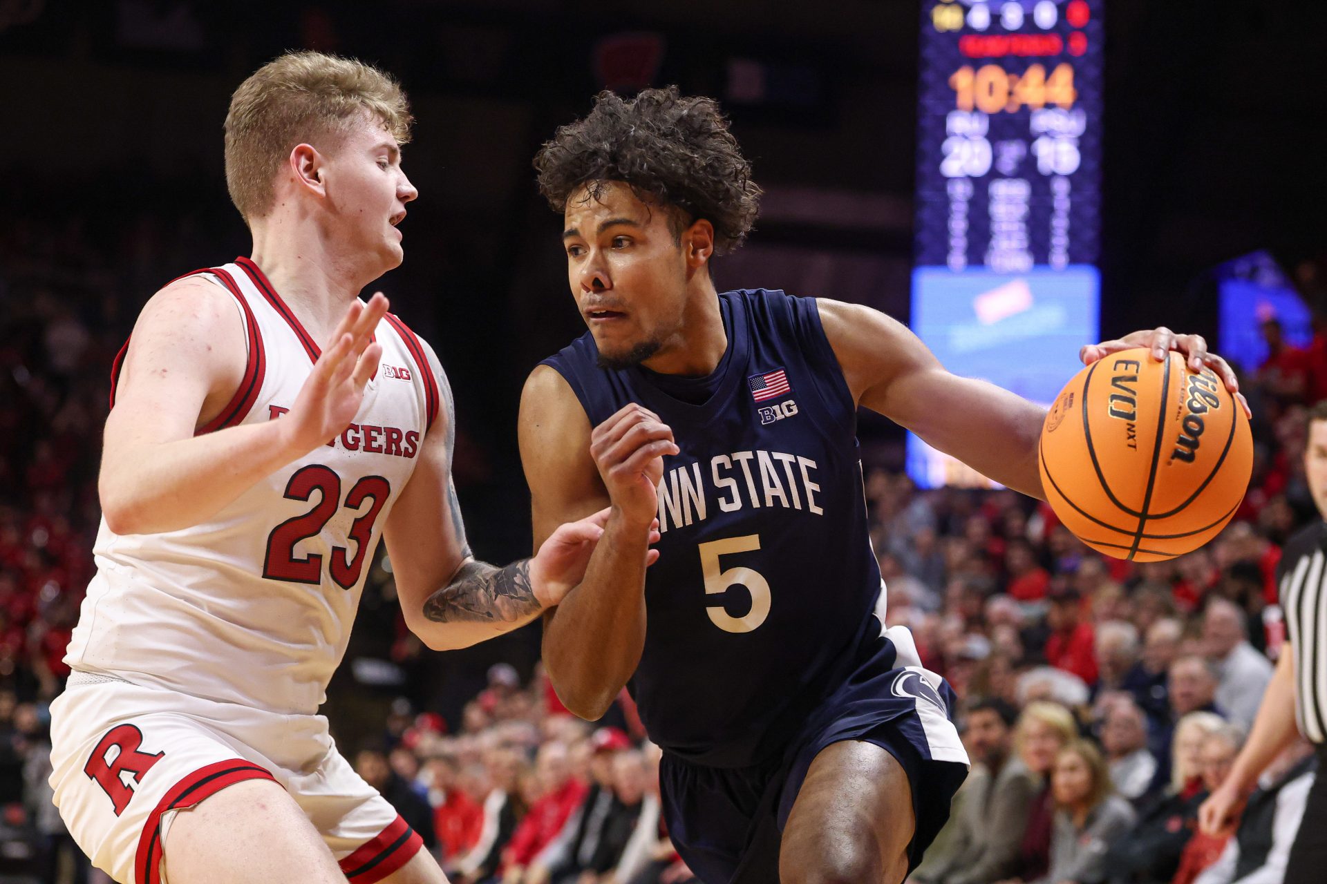 Penn State Nittany Lions guard Puff Johnson (5) drives to the basket as Rutgers Scarlet Knights guard PJ Hayes IV (23) defends during the first half at Jersey Mike's Arena.
