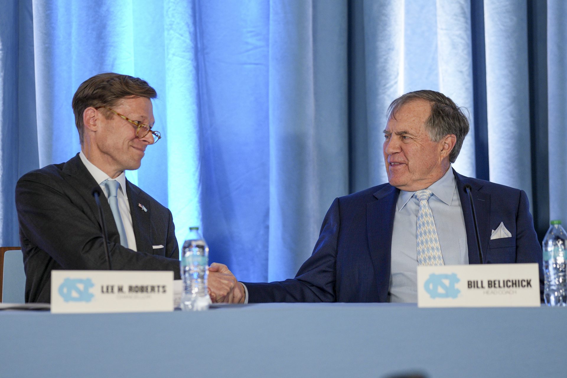 North Carolina Tar Heels new head coach Bill Belichick shakes hands with chancellor Lee Roberts at Loudermilk Center for Excellence.