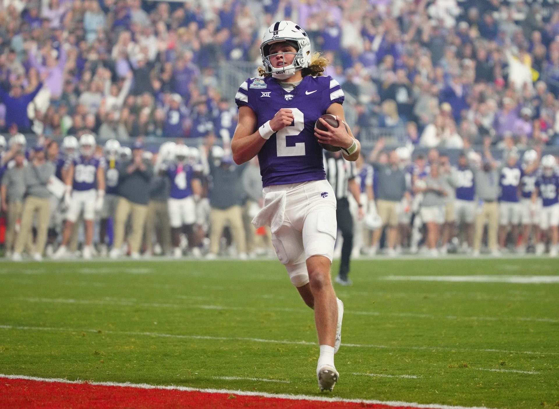 Kansas State quarterback Avery Johnson (2) scores a touchdown against Rutgers during first half of the Rate Bowl at Chase Field on Dec. 26, 2024, in Phoenix.