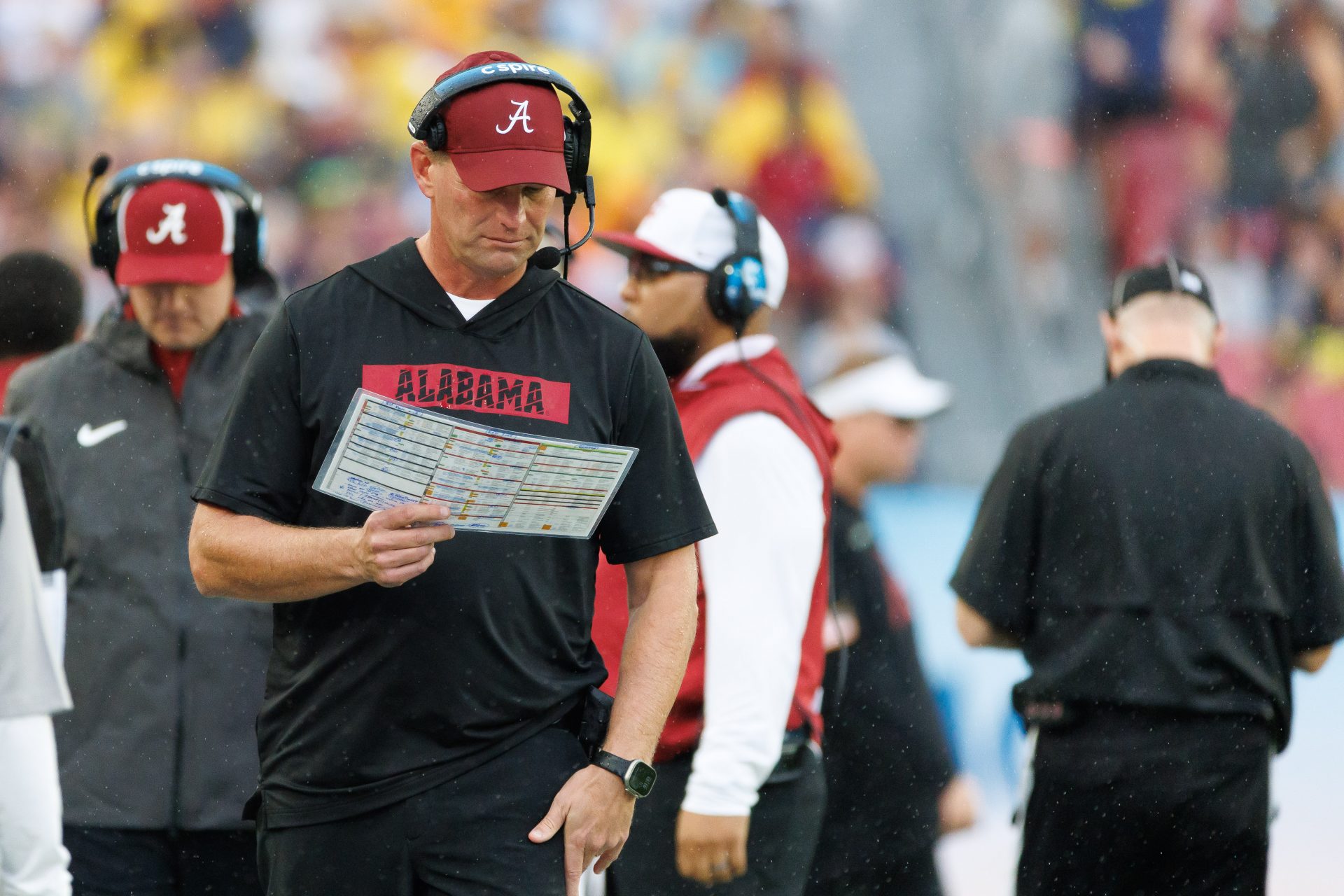 Alabama Crimson Tide head coach Kalen DeBoer reads the playcard against the Michigan Wolverines during the first half at Raymond James Stadium.