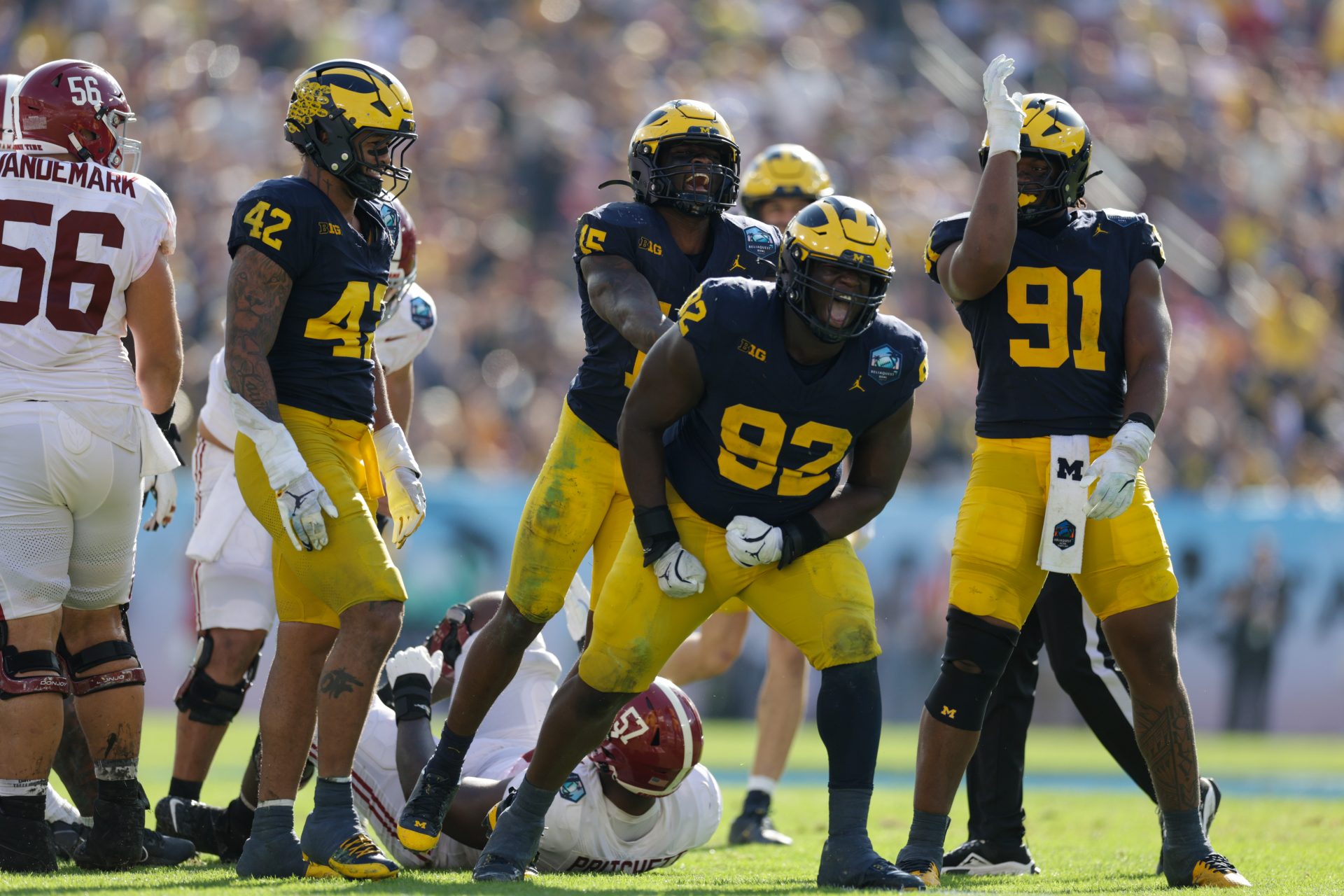 Alabama Crimson Tide quarterback Jalen Milroe (4) is sacked by Michigan Wolverines defensive lineman Ike Iwunnah (92) in the third quarter during the ReliaQuest Bowl at Raymond James Stadium.