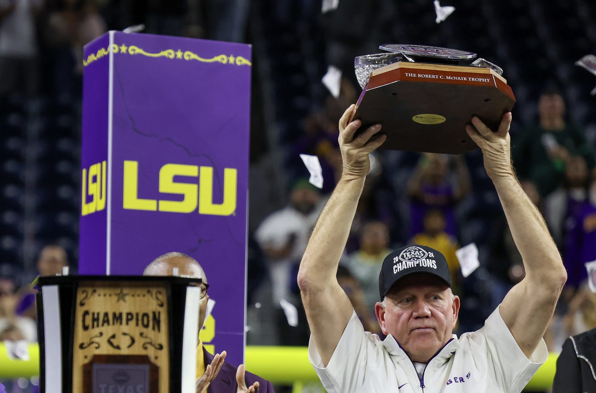 LSU Tigers head coach Brian Kelly holds up the trophy after defeating the Baylor Bears in the Kinder’s Texas Bowl in the second half at NRG Stadium.