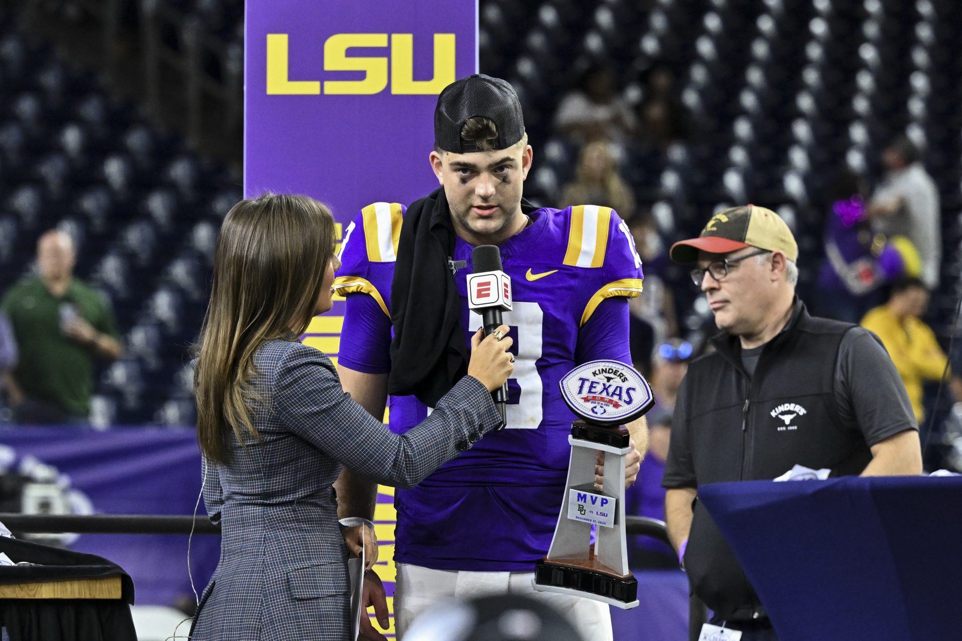 LSU Tigers quarterback Garrett Nussmeier (13) speaks after receiving the MVP trophy after the game against the Baylor Bears at NRG Stadium. The Tigers defeat the Bears 44-31.