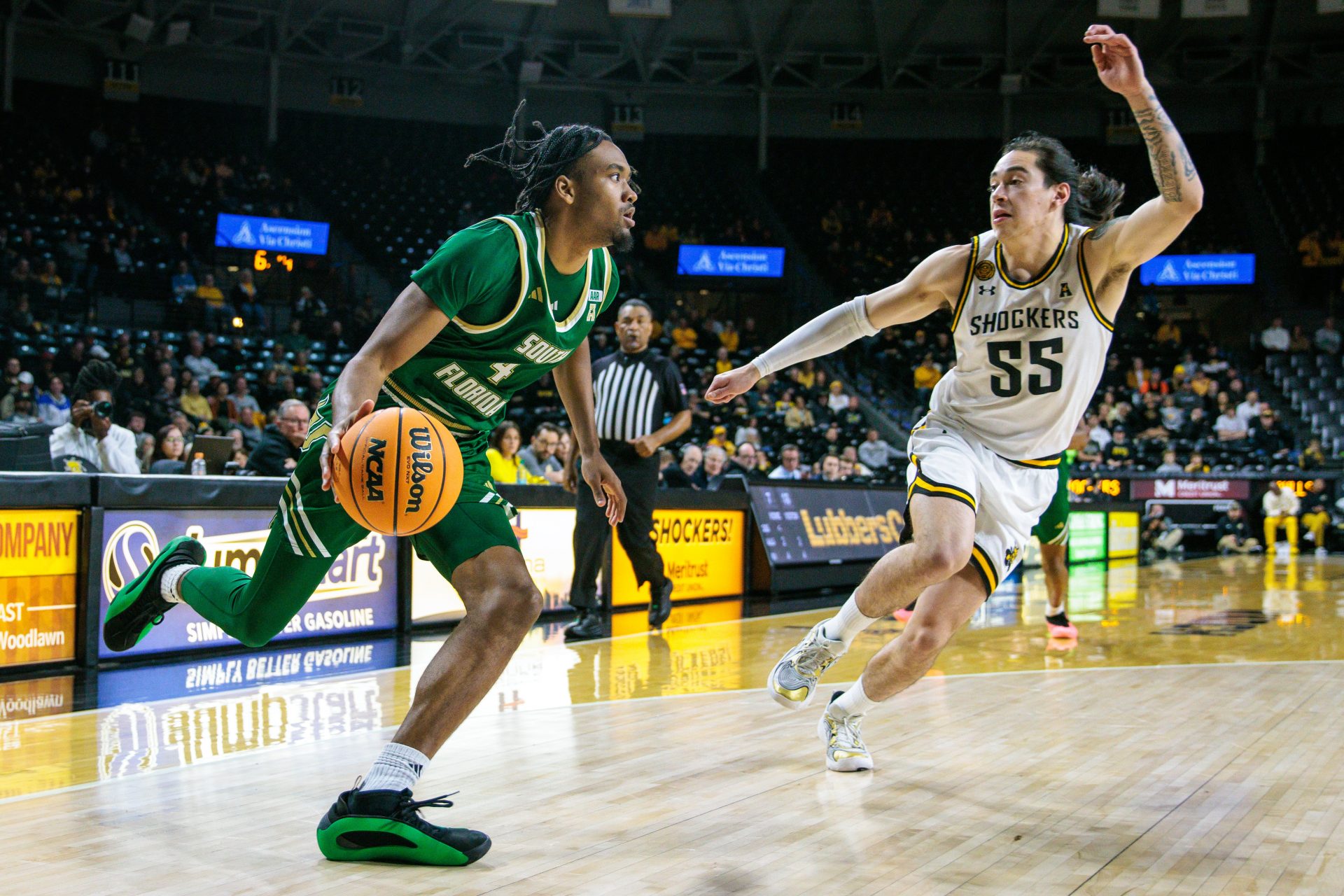 South Florida Bulls guard Kobe Knox (4) drives to the basket around Wichita State Shockers guard Bijan Cortes (55) during the first half at Charles Koch Arena.