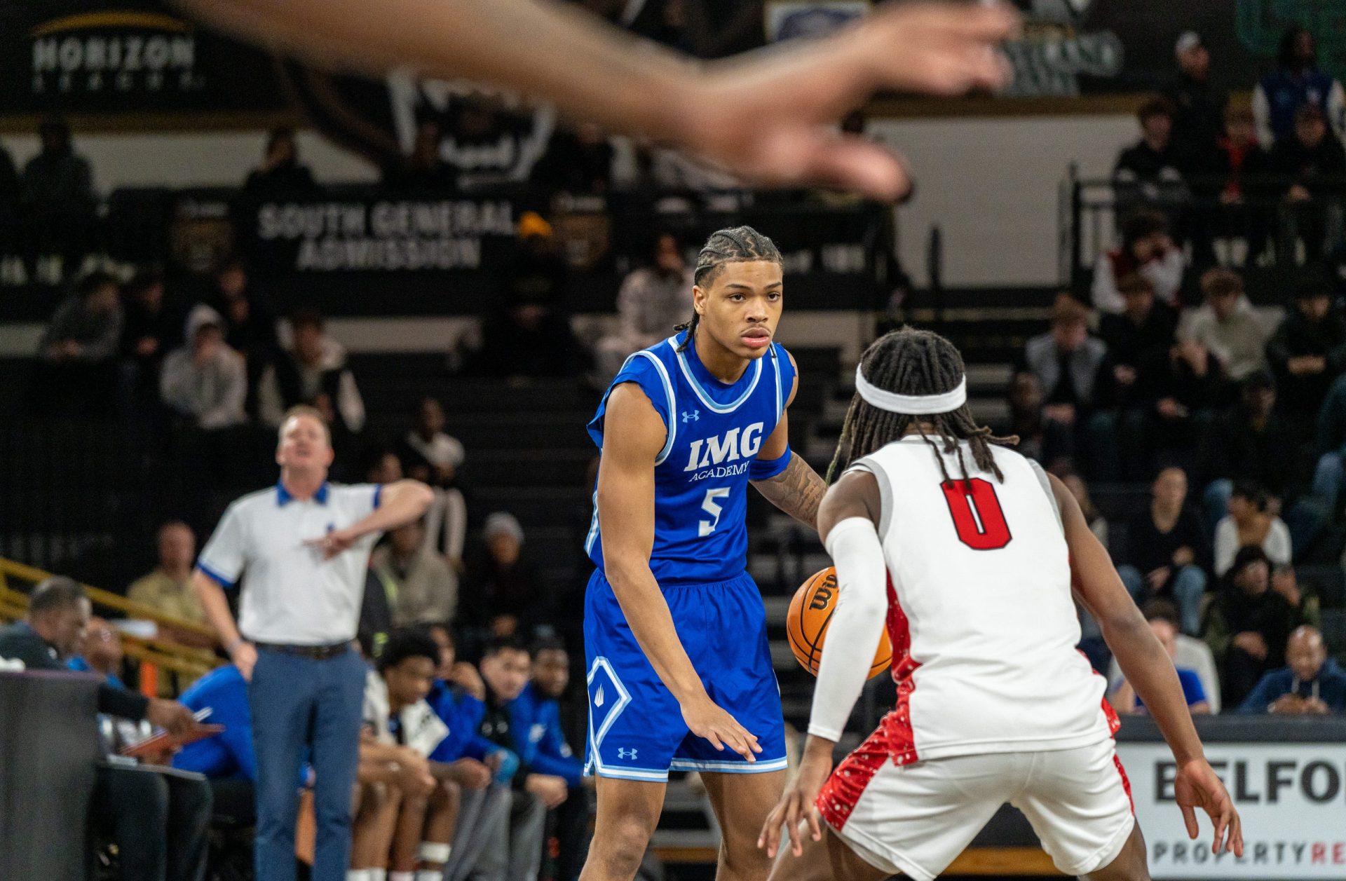 IMG Academy’s Darius Acuff (5) dribbles the ball against Orchard Lake Saint Mary’s Sharod Barnes (0) at Oakland University in Rochester on Thursday, Jan. 9, 2025.